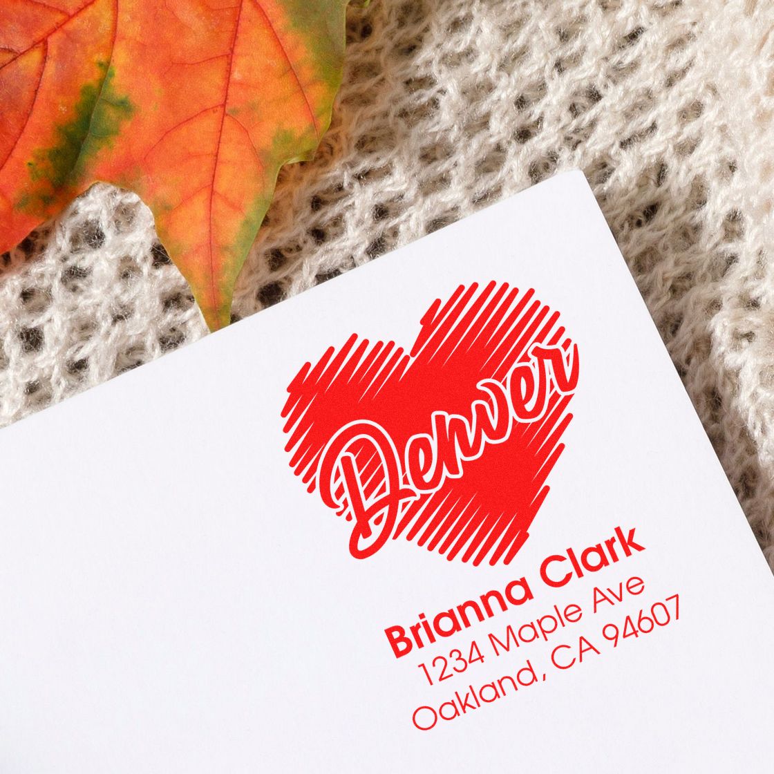 Custom return address rubber stamp with heart design and Brianna Clark address for Oakland, CA mailings.