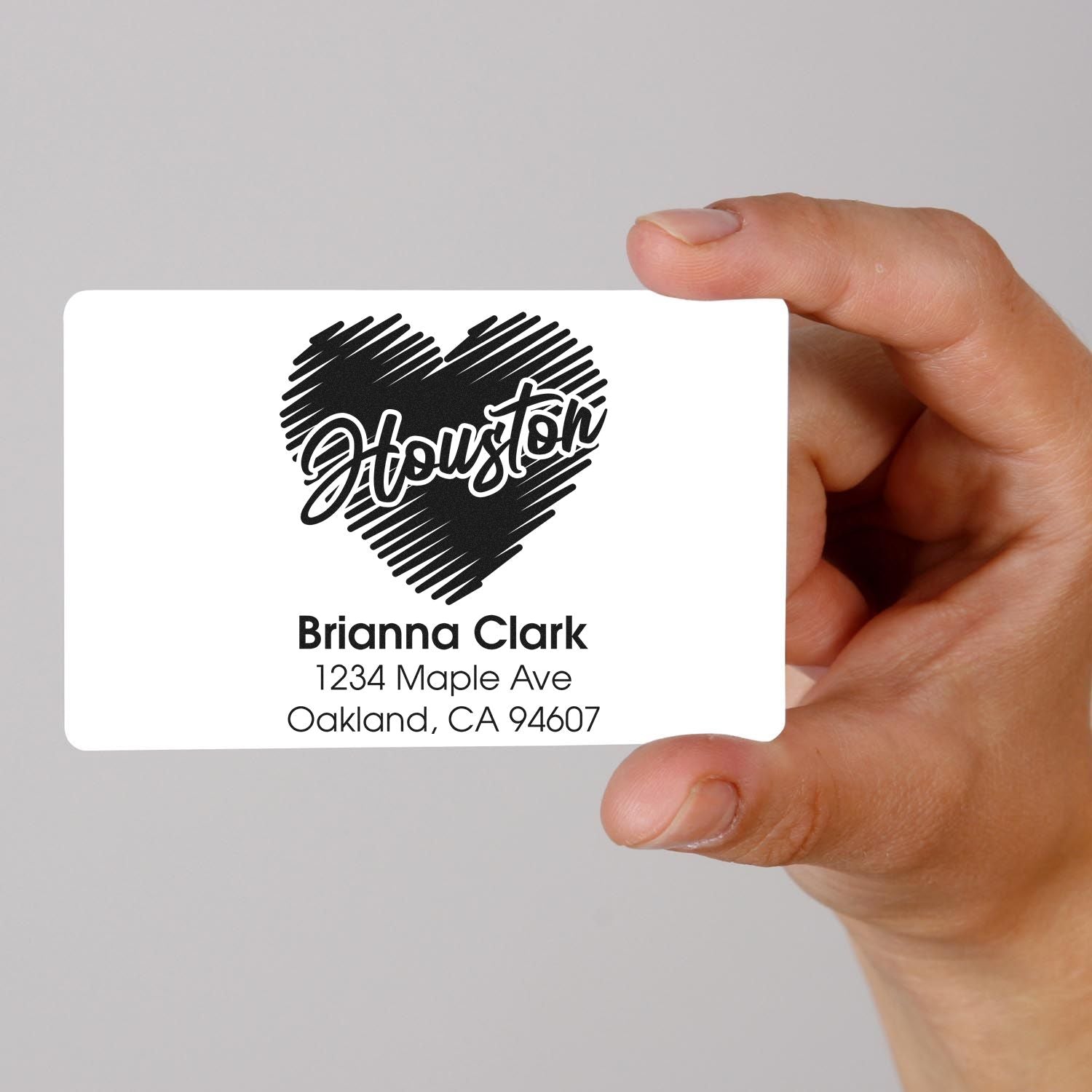Custom Houston heart return address rubber stamp mockup with Brianna Clark address, held in hand