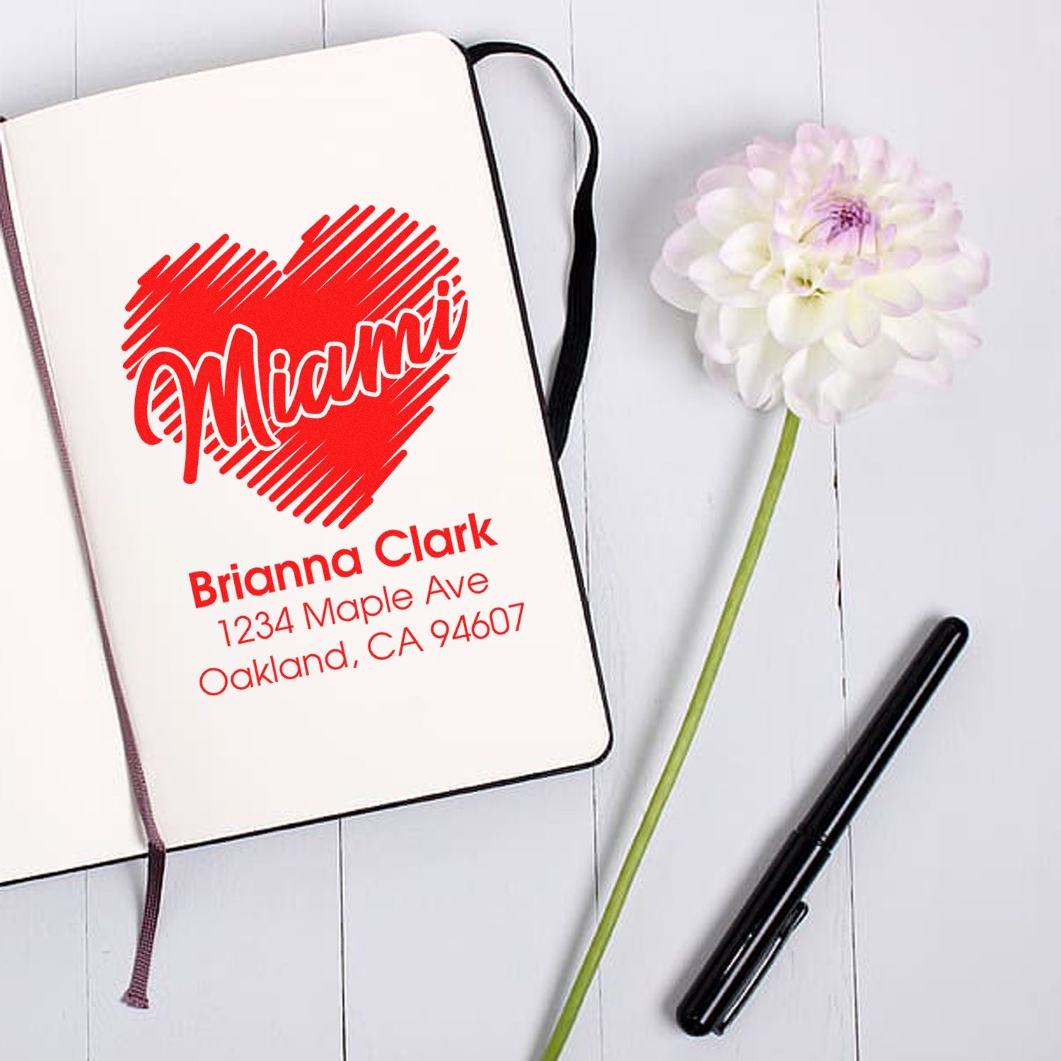 Custom rubber address stamp with heart design for Brianna Clark, featuring name and Oakland, CA mailing address.