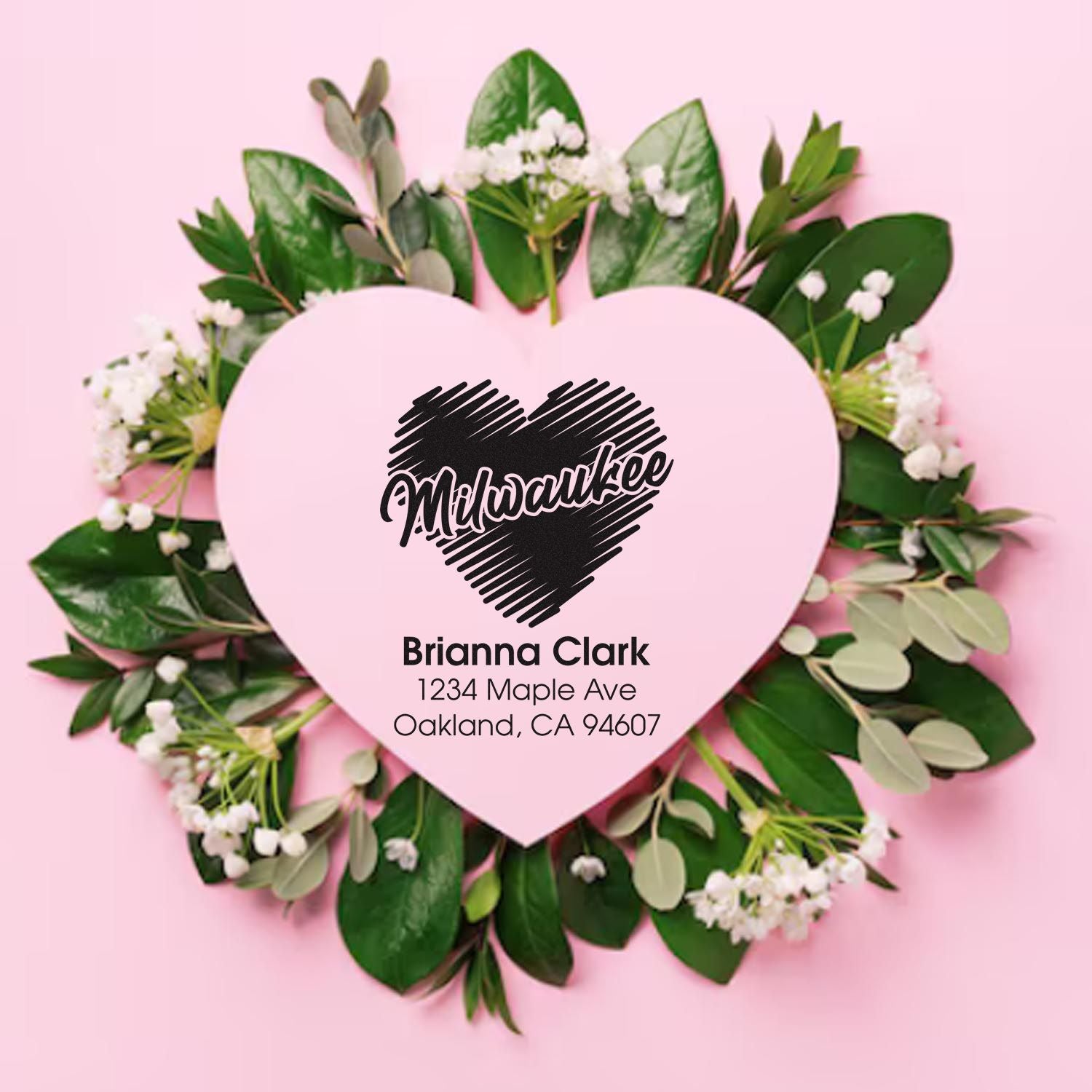 Custom Milwaukee address rubber stamp with heart logo, floral wreath, and Brianna Clark Oakland, CA return address.