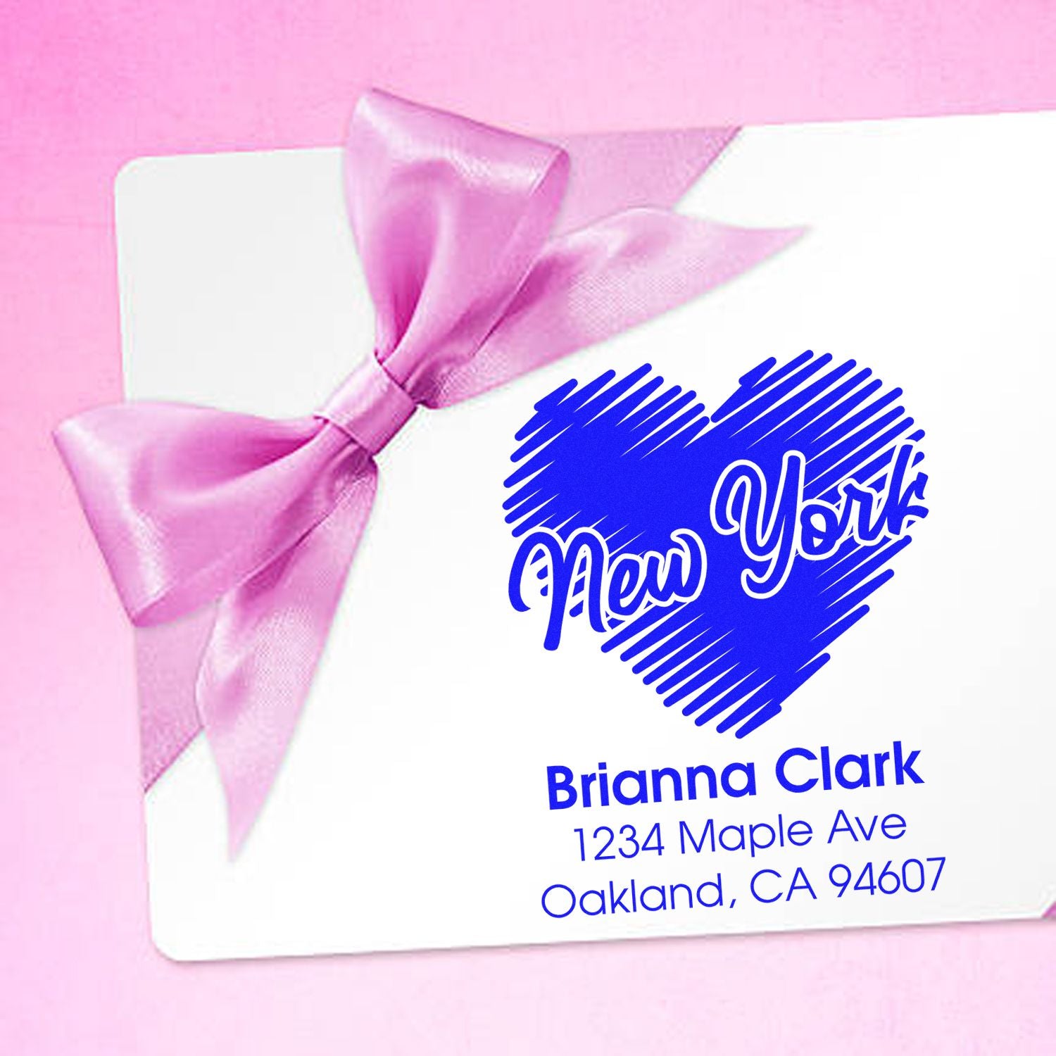 Personalized heart return address rubber stamp with New York script, pink ribbon design, and custom name/address.