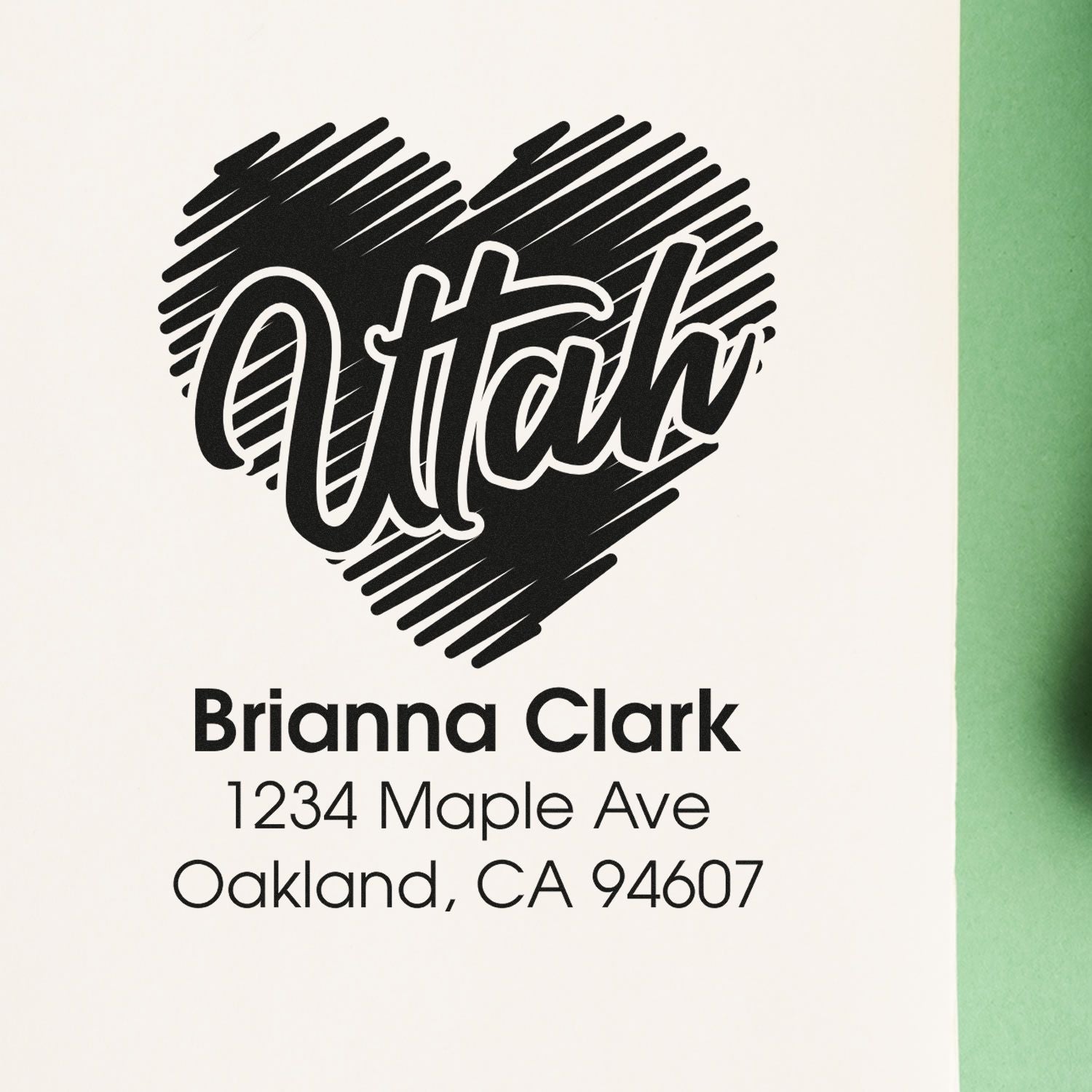 Personalized return address rubber stamp with heart logo, Brianna Clark, 1234 Maple Ave, Oakland, CA 94607.