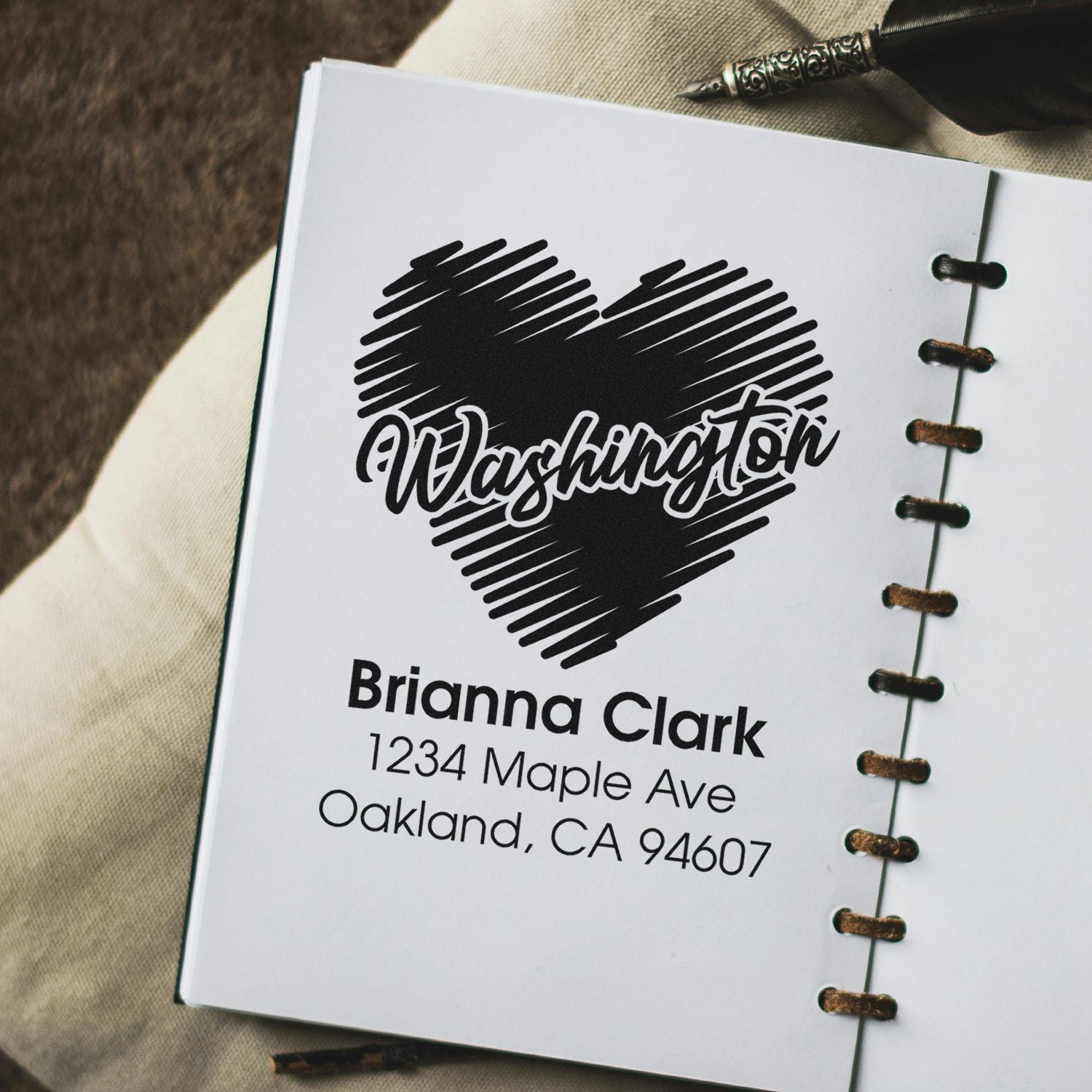Personalized return address rubber stamp with heart logo for Brianna Clark, Oakland, CA.