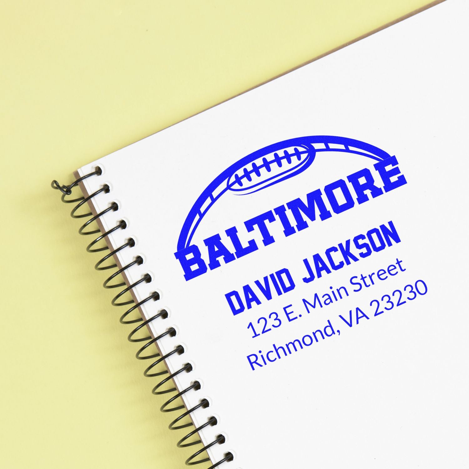 Custom Baltimore football address rubber stamp imprint with name and mailing address on a notebook.