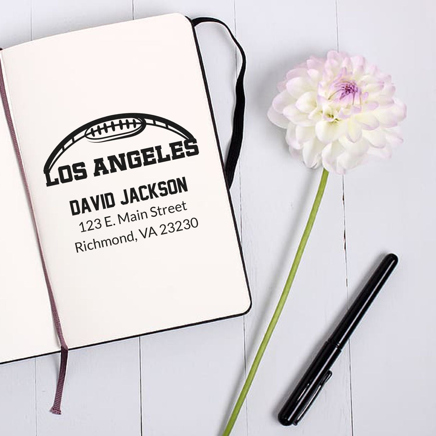 Personalized football address rubber stamp impression on notebook with Los Angeles name and address.