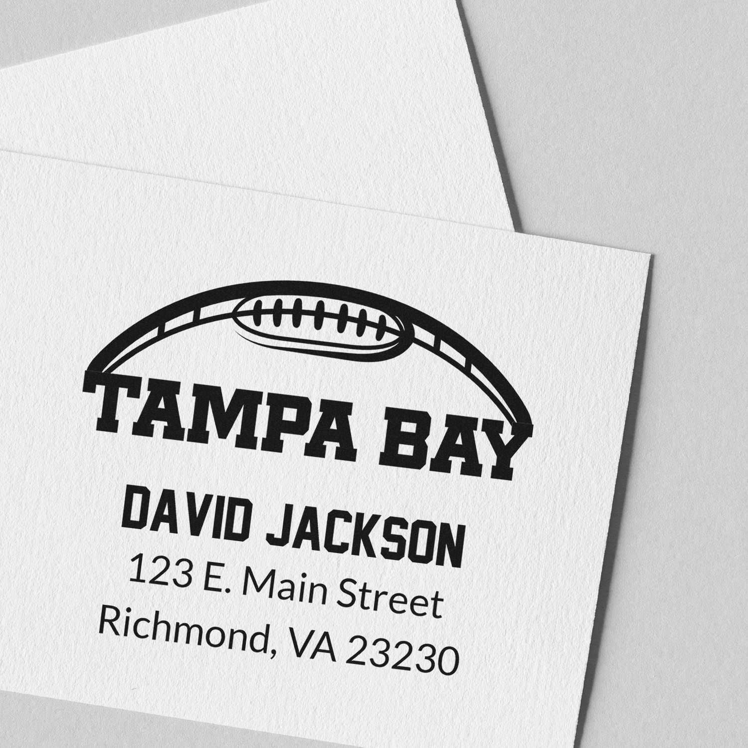 Custom Tampa Bay return address rubber stamp with football logo, name, and mailing address for business use.