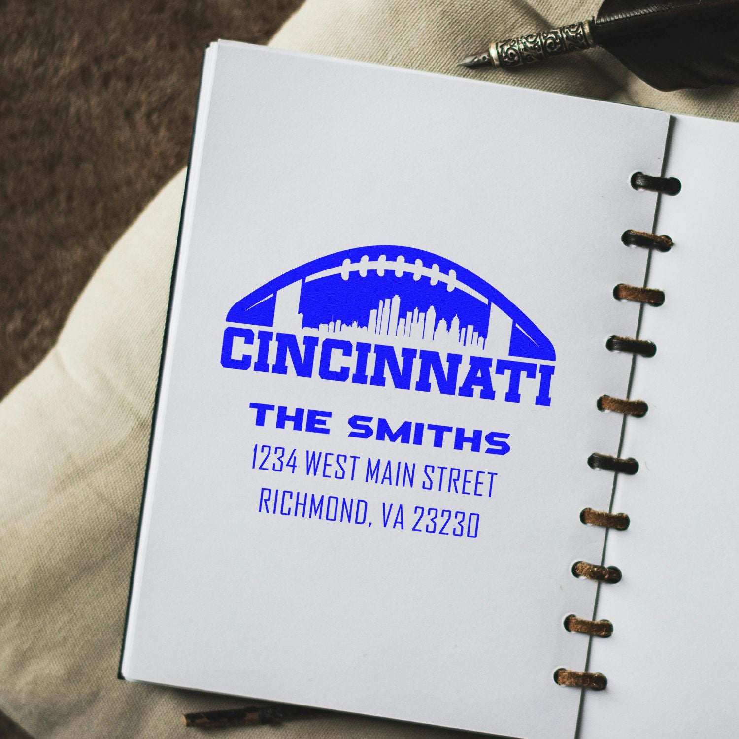 Personalized return address rubber stamp imprint for The Smiths with Cincinnati football skyline on notebook paper.