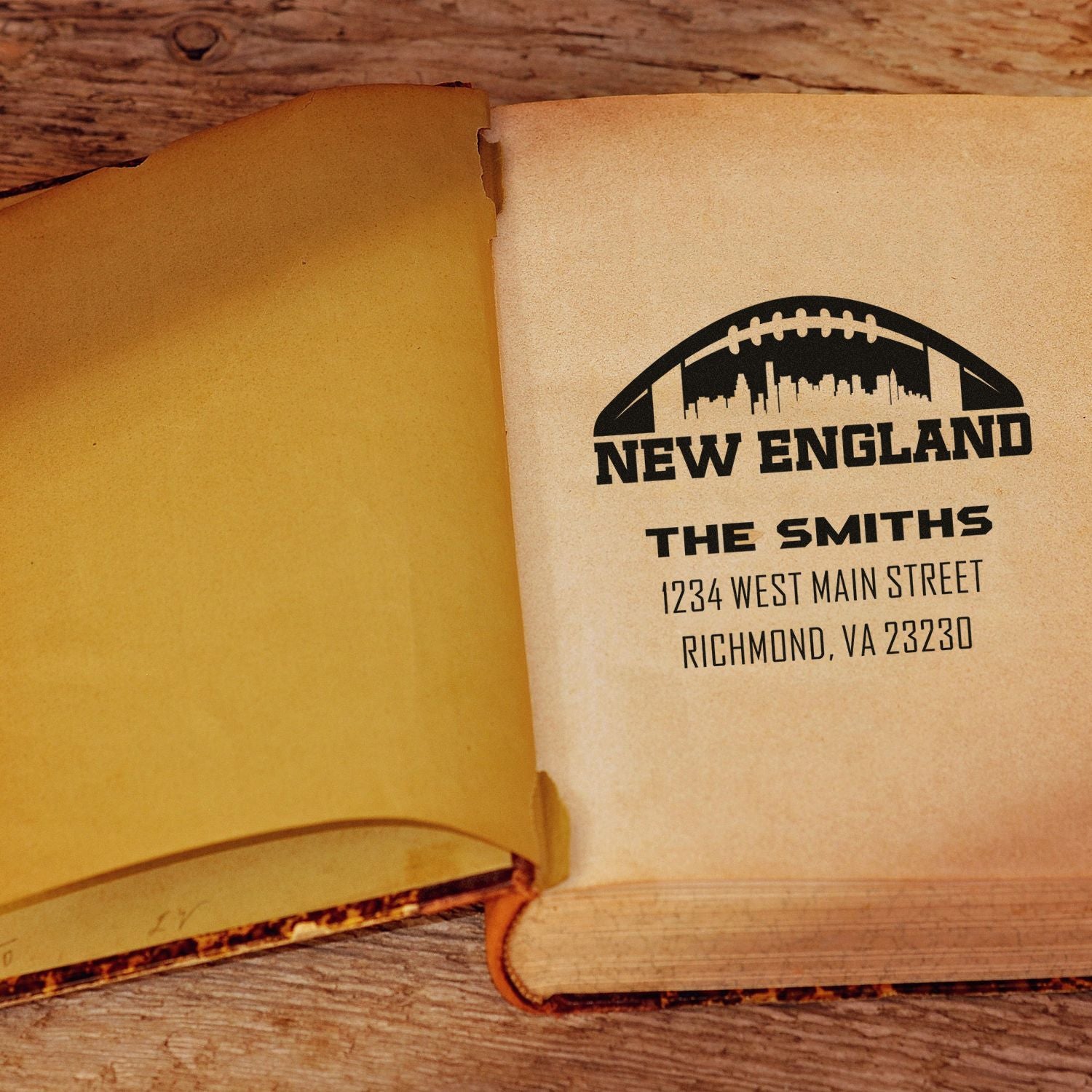 Custom New England address rubber stamp with football logo for The Smiths on notebook paper.