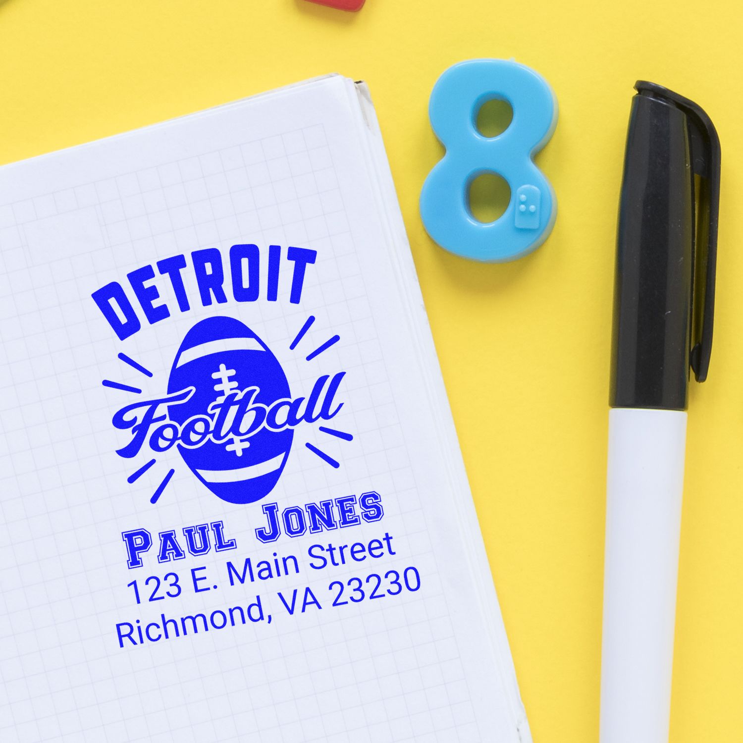 Detroit football custom rubber stamp imprint with name and address on notebook, shown with marker on yellow background.