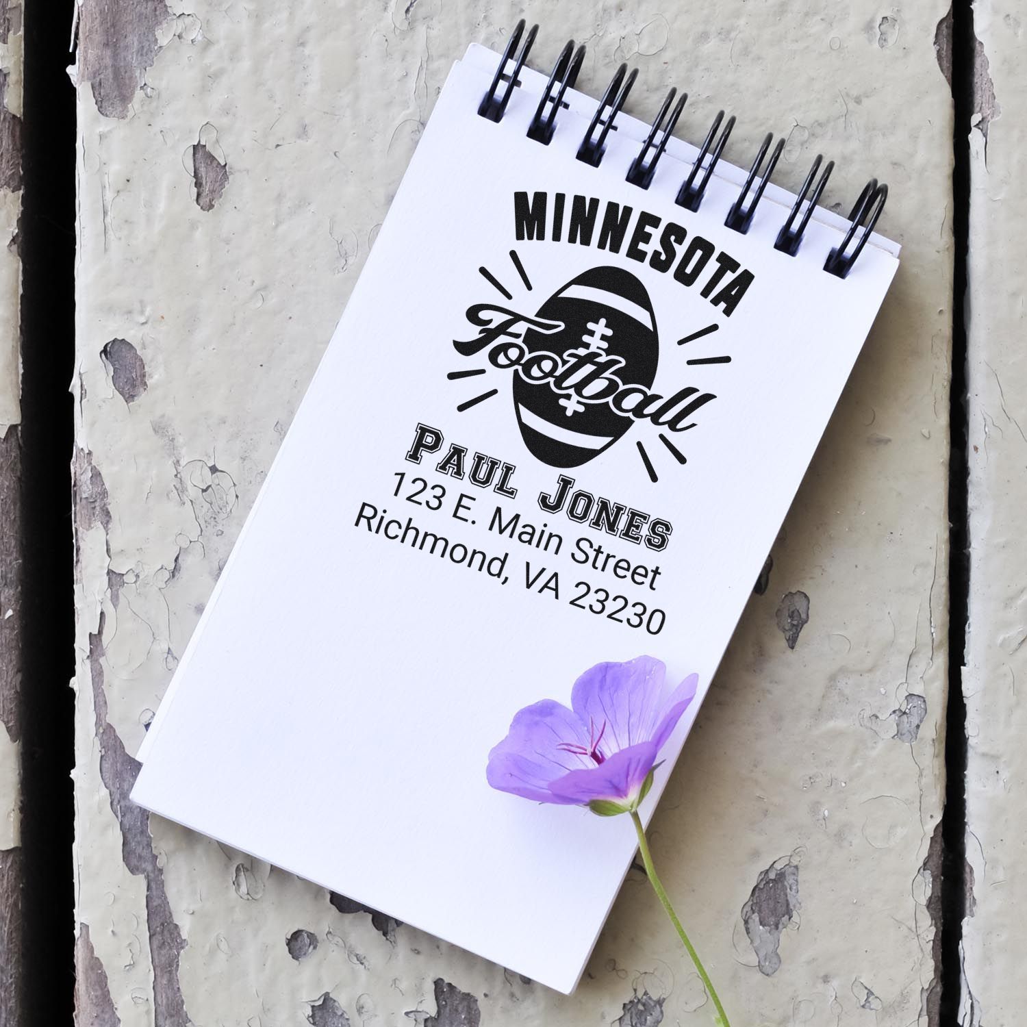 Custom Minnesota football address rubber stamp design with Paul Jones name and Richmond, VA address on a spiral notebook.