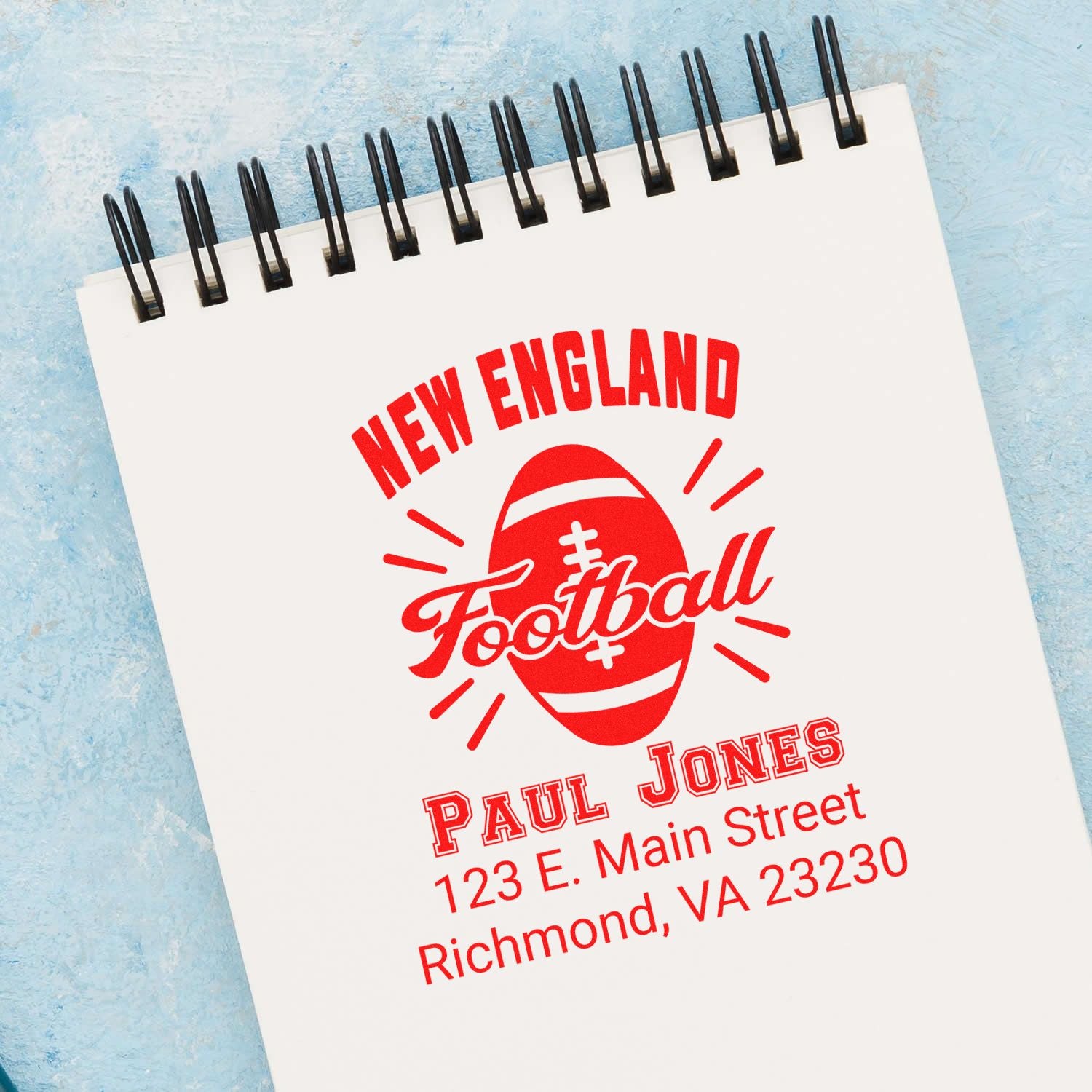Custom New England Football rubber stamp mockup with personalized name, address, and football logo.
