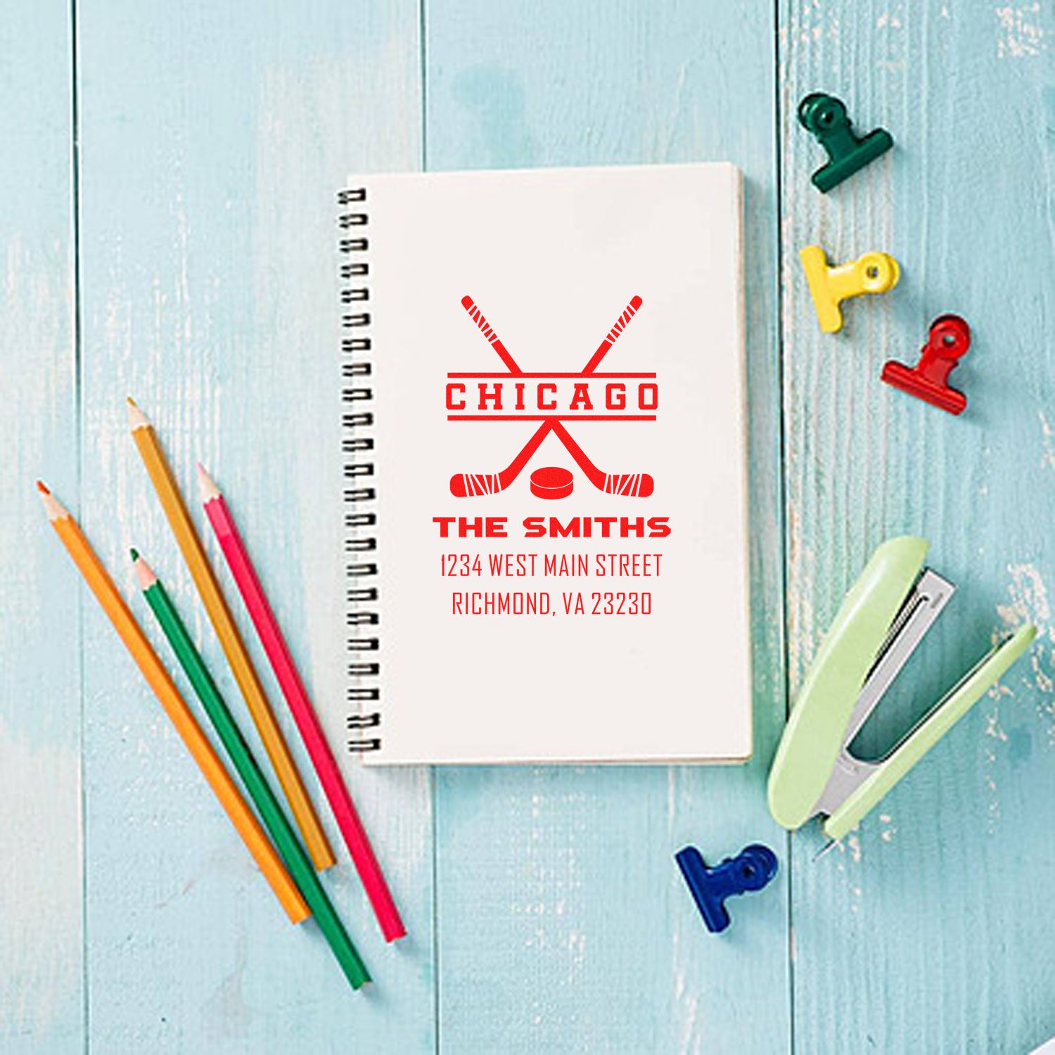 Custom sports logo rubber stamp on notebook with Chicago, The Smiths, and address for personalized stationery.