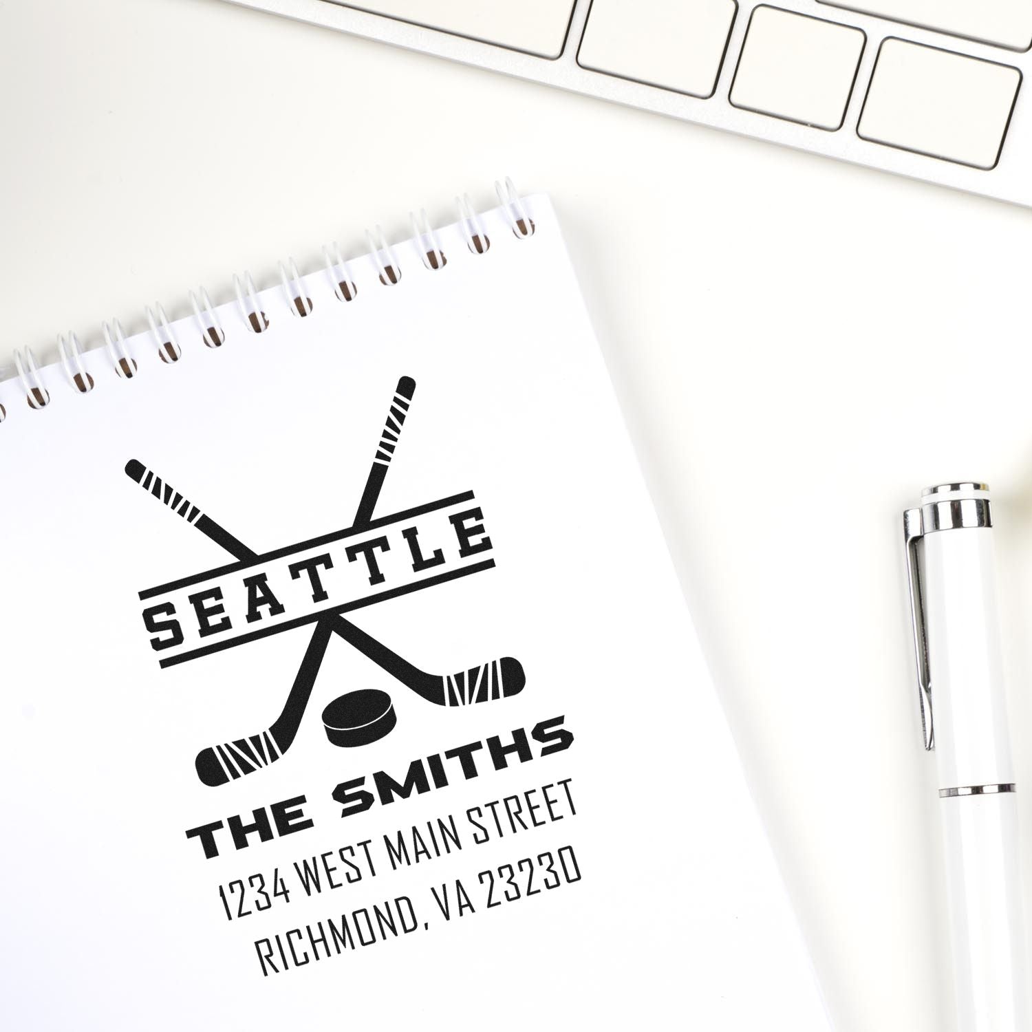 Custom hockey rubber stamp with crossed sticks for Seattle family address, featuring The Smiths and personalized return details.