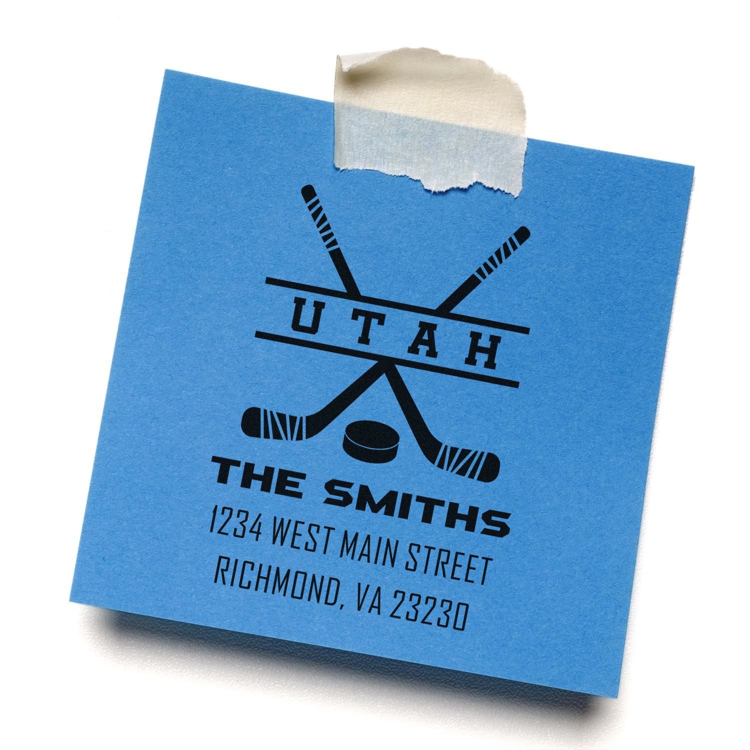 Custom hockey return address rubber stamp with family name, street address, and team logo on blue note