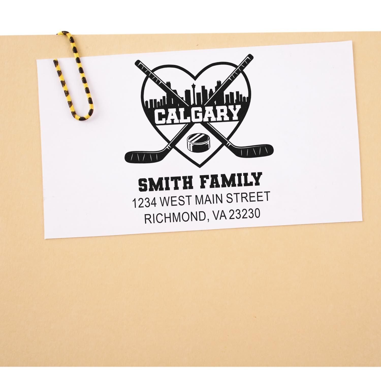 Personalized hockey return address rubber stamp with Calgary skyline, crossed sticks, and Smith family address.