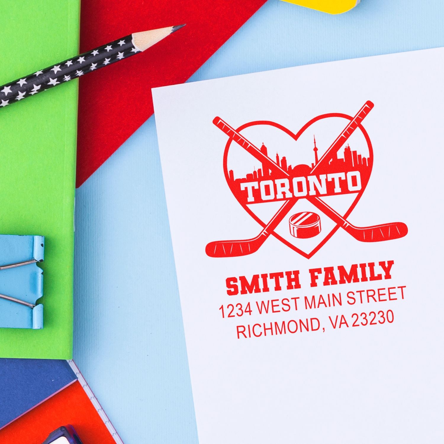 Custom hockey family address rubber stamp with Toronto design, name, street, and city on stationery.