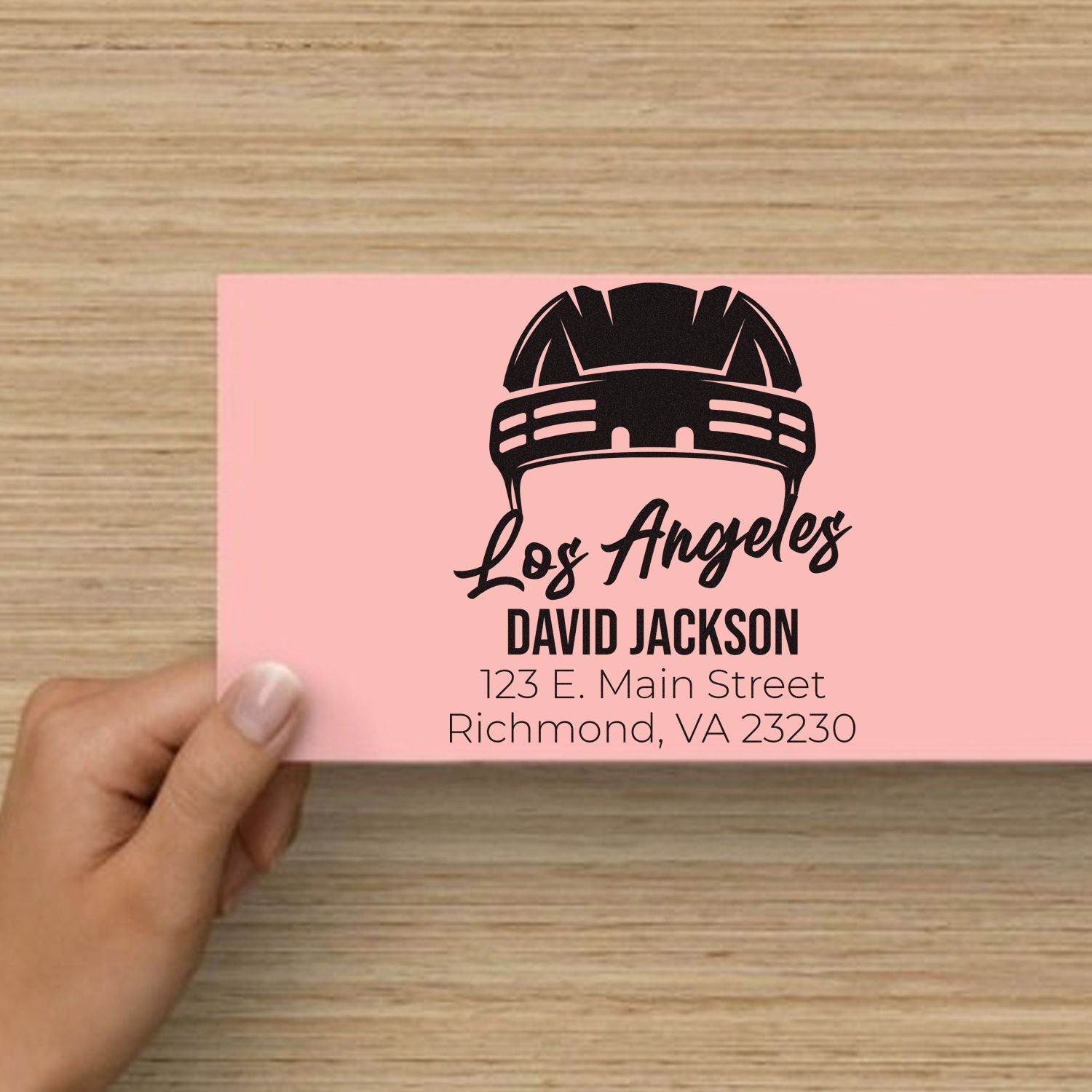 Custom logo rubber stamp design with helmet graphic, Los Angeles text, and personalized name and address.