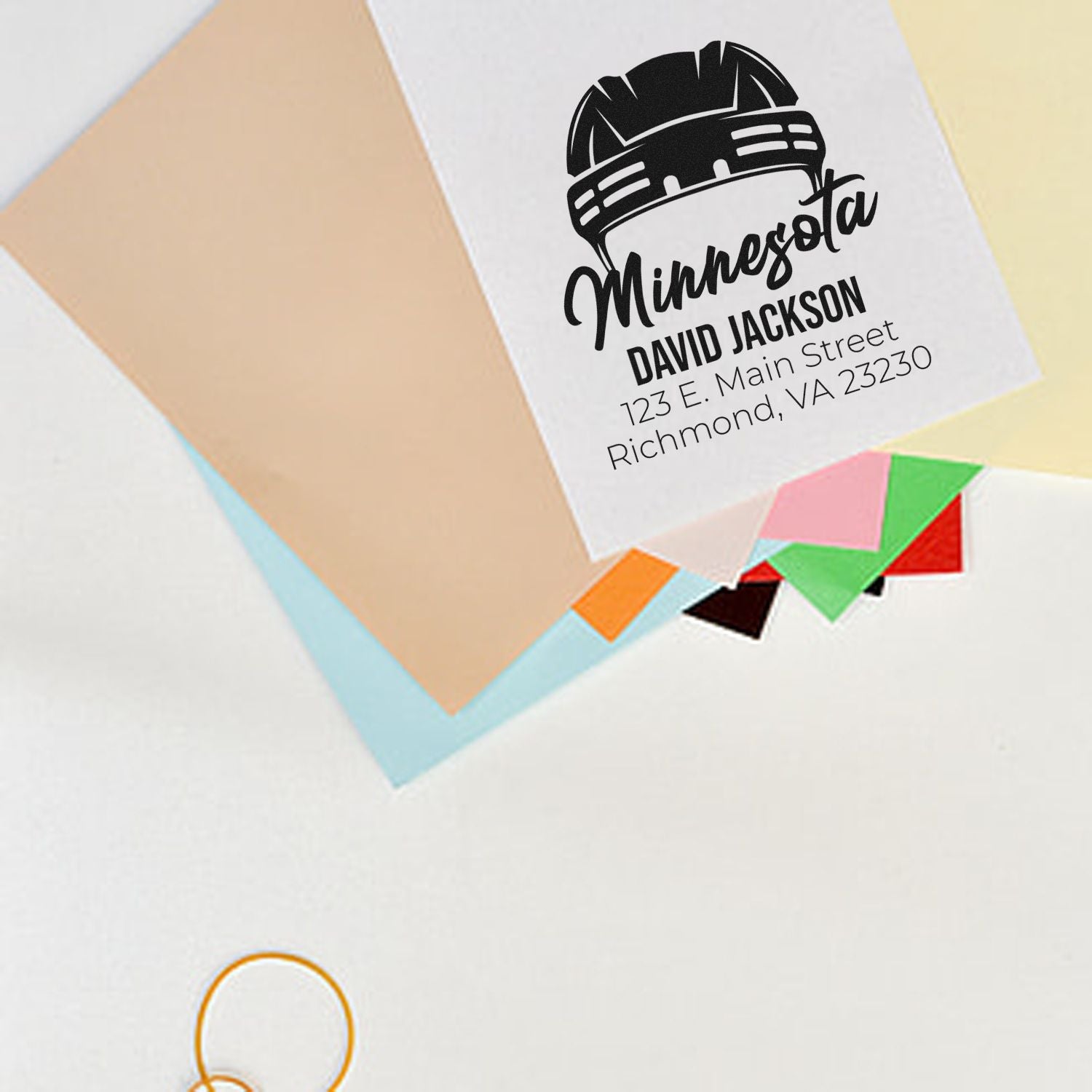 Custom return address rubber stamp mockup with hard hat logo, personalized name, and address on stationery.