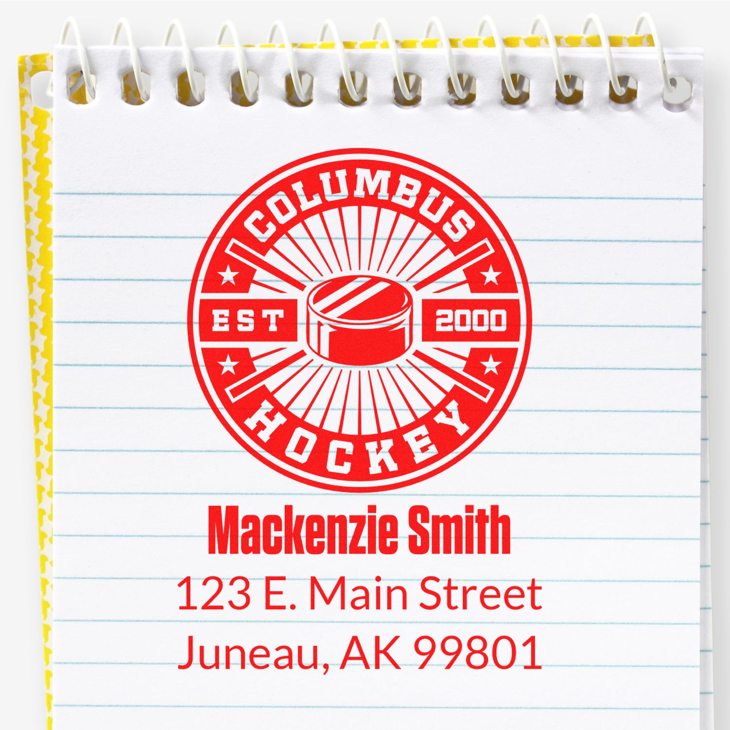 Custom address rubber stamp with Columbus Hockey logo, name, and address on a notebook page.