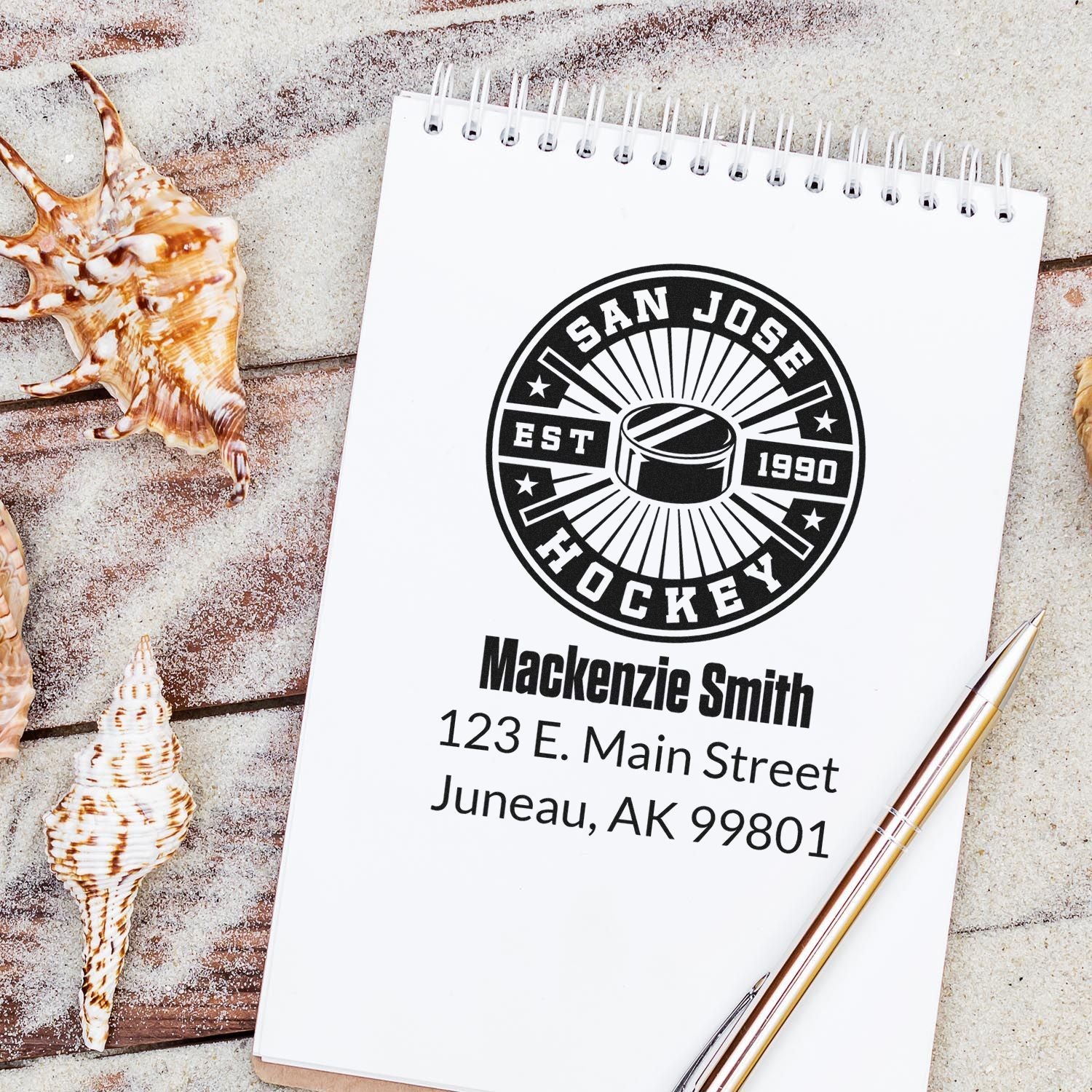 Custom hockey rubber stamp return address design on notebook with personalized name and address.