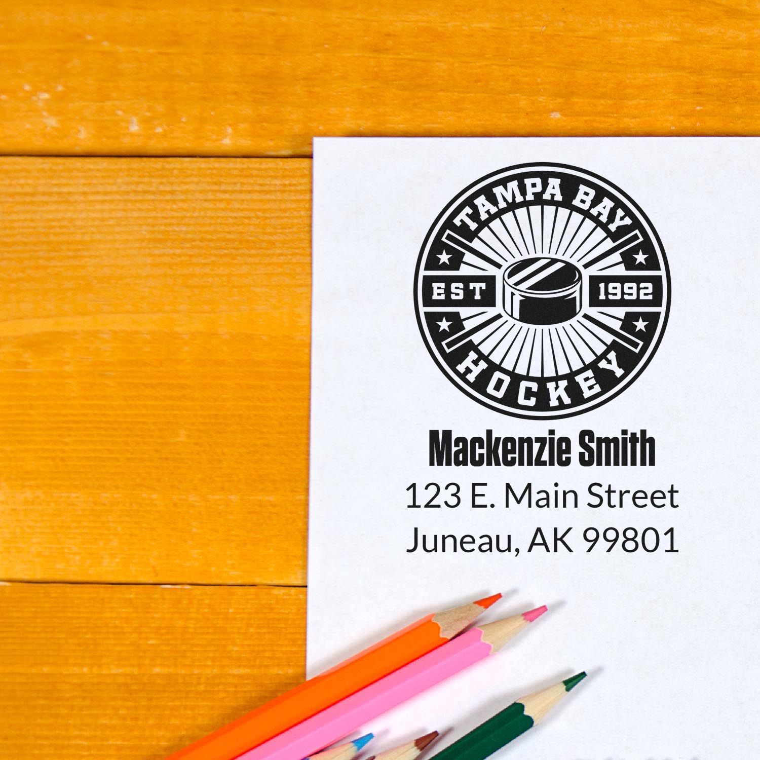 Custom rubber stamp mockup featuring a Tampa Bay Hockey logo, name, and address for personalized branding.