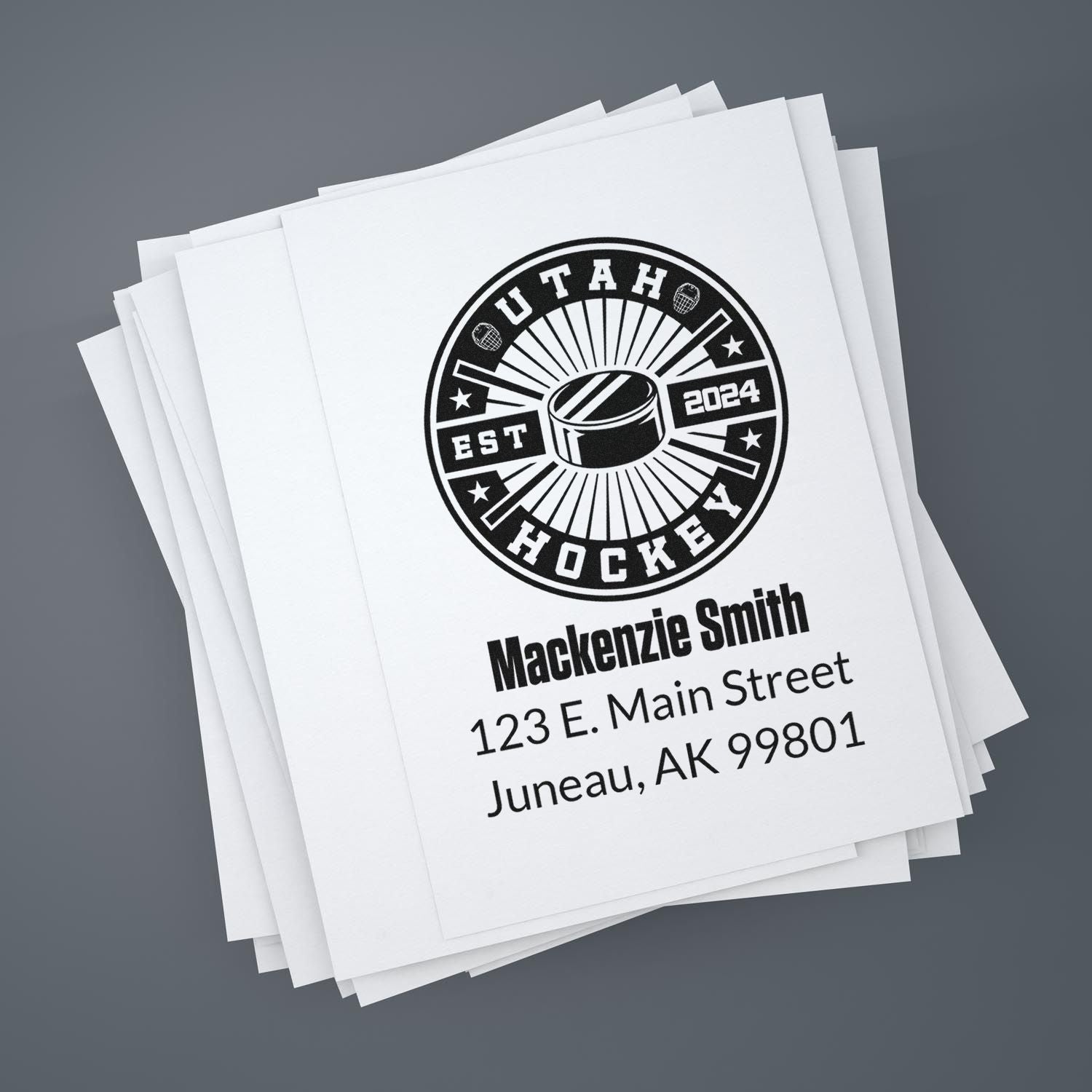 Custom hockey rubber stamp with personalized name and address, featuring Utah Hockey 2024 logo on stacked paper.