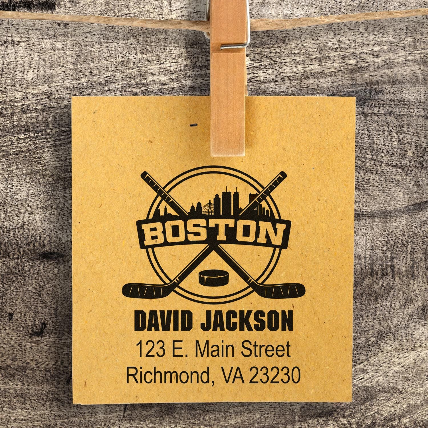 Custom Boston hockey rubber stamp with name and address, featuring crossed sticks and skyline for personalized mailings.