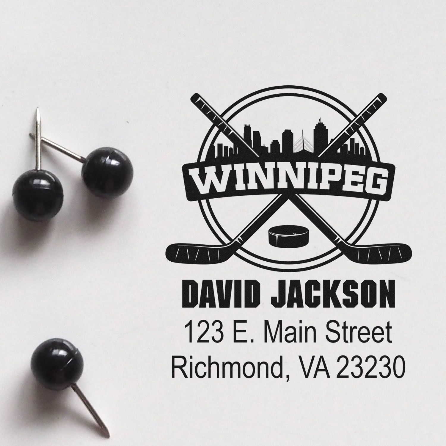 Custom Winnipeg hockey rubber stamp design with name, address, skyline, and crossed sticks for personalized branding.