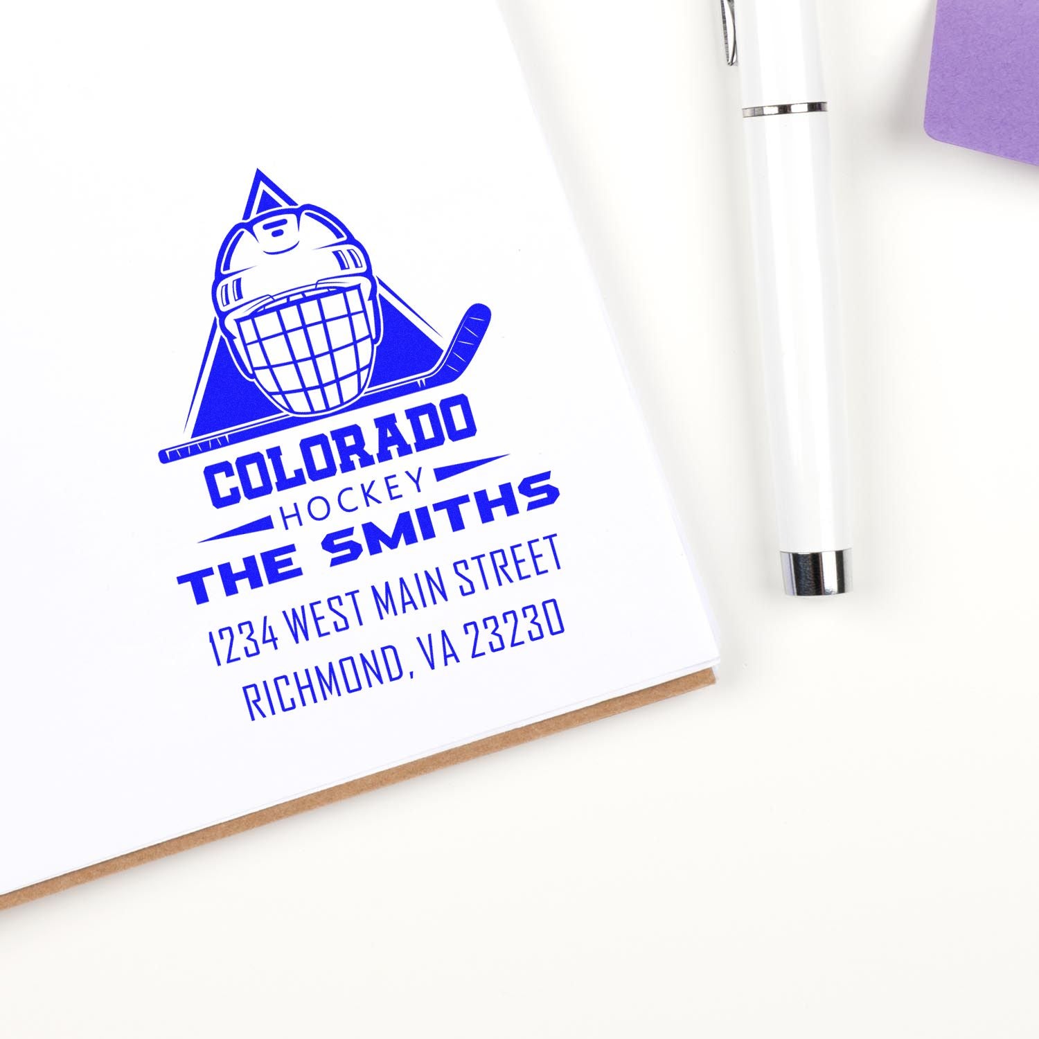 Custom rubber stamp featuring a Colorado Hockey team logo, name, and address for personalized sports stationery.