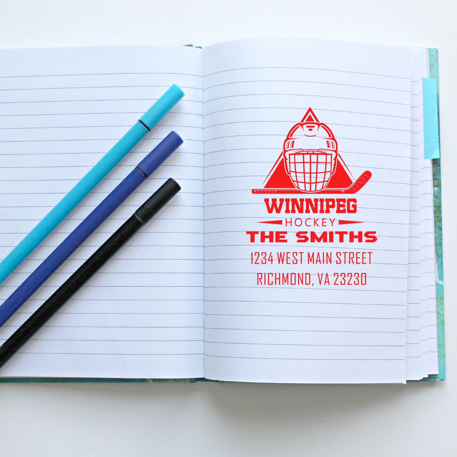 Personalized hockey rubber stamp imprint on notebook pages with Winnipeg logo, family name, and return address.