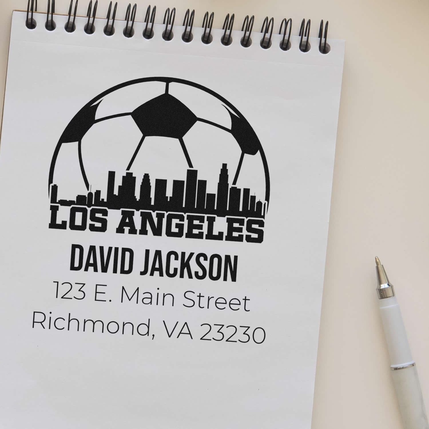 Custom address rubber stamp with soccer ball and Los Angeles skyline for David Jackson, 123 E. Main Street, Richmond, VA.