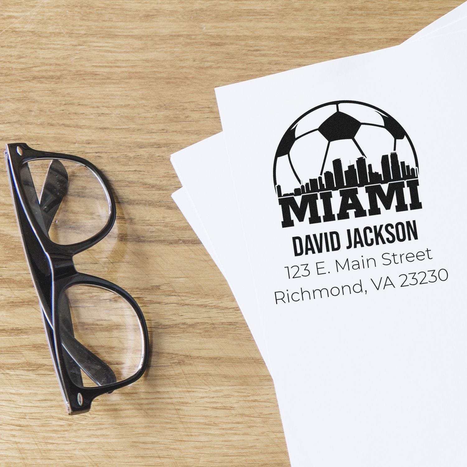 Custom rubber stamp impression with Miami soccer logo, name, and address for branded business correspondence.