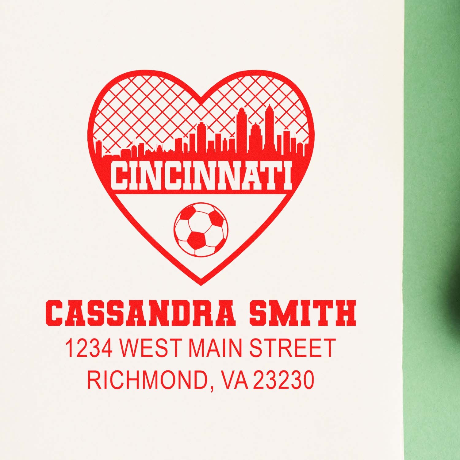 Custom rubber stamp proof with Cincinnati heart skyline, soccer ball, and personalized Cassandra Smith address text.