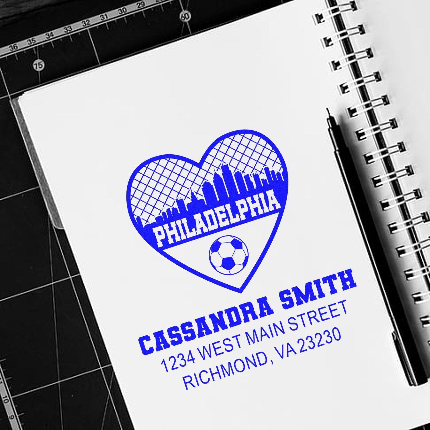 Personalized rubber stamp with Philadelphia skyline heart logo, soccer ball, and Cassandra Smith address for custom mail.