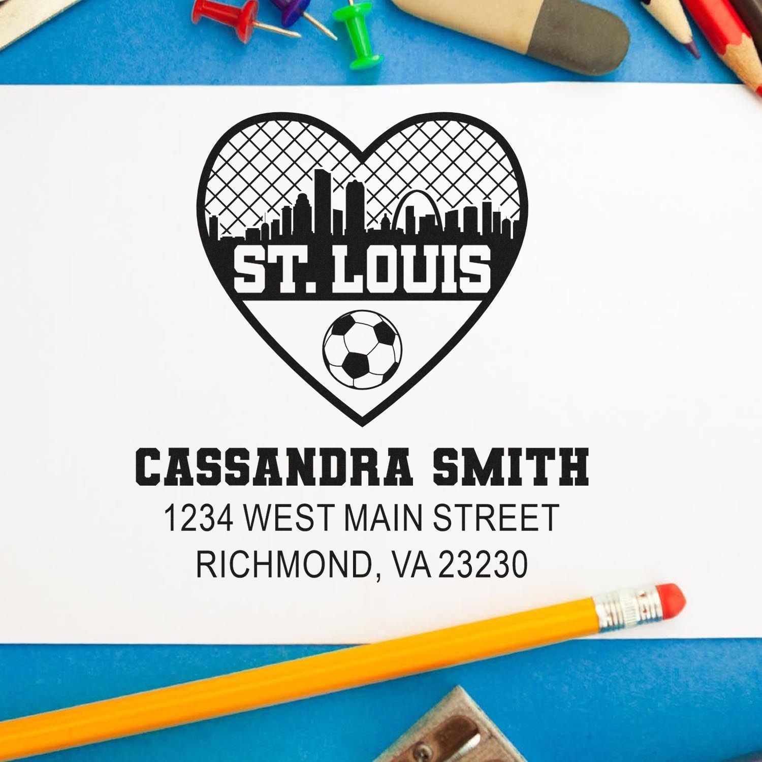 Custom rubber stamp design with St. Louis heart skyline, soccer ball, and personalized name and address for return mailing.