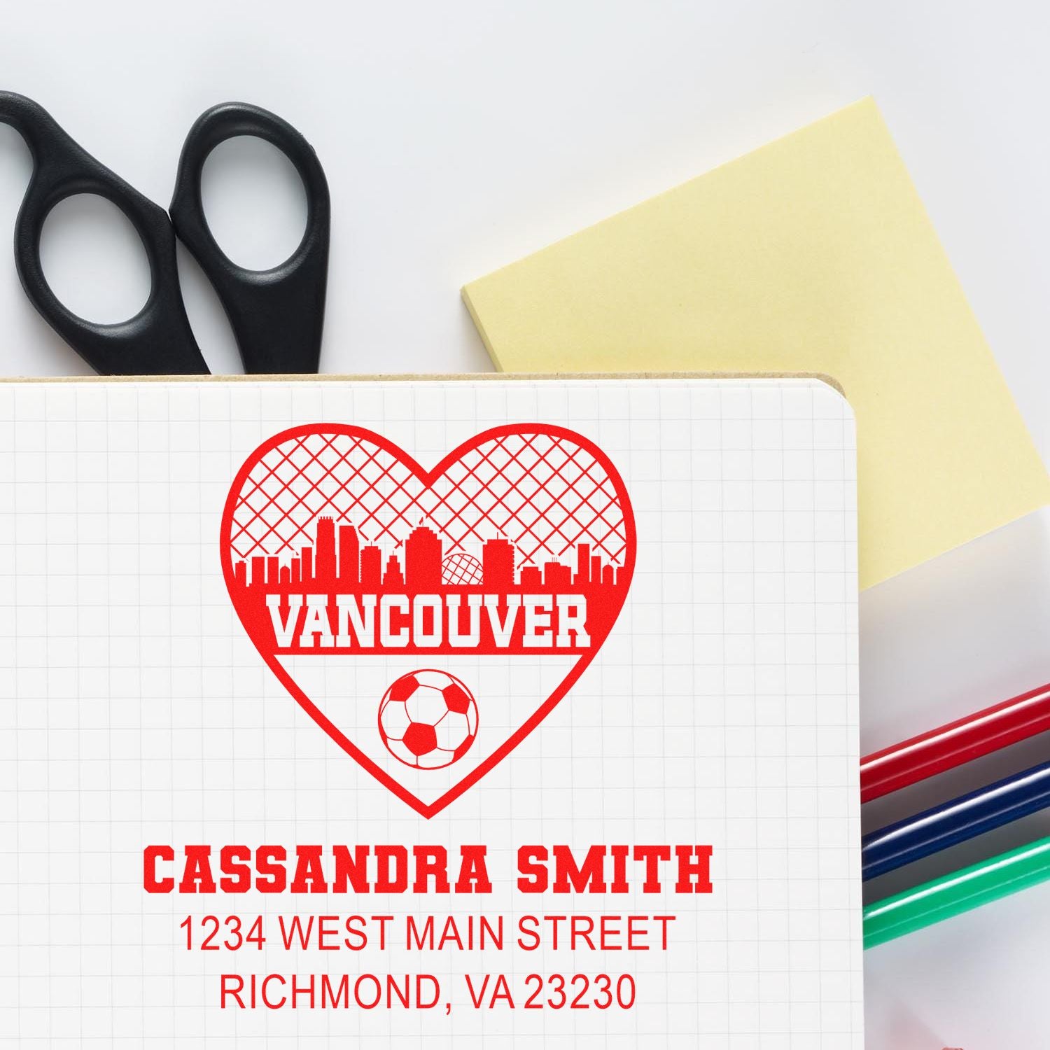 Custom rubber stamp design with Vancouver heart logo, soccer ball, and Cassandra Smith address for personalized stationery.