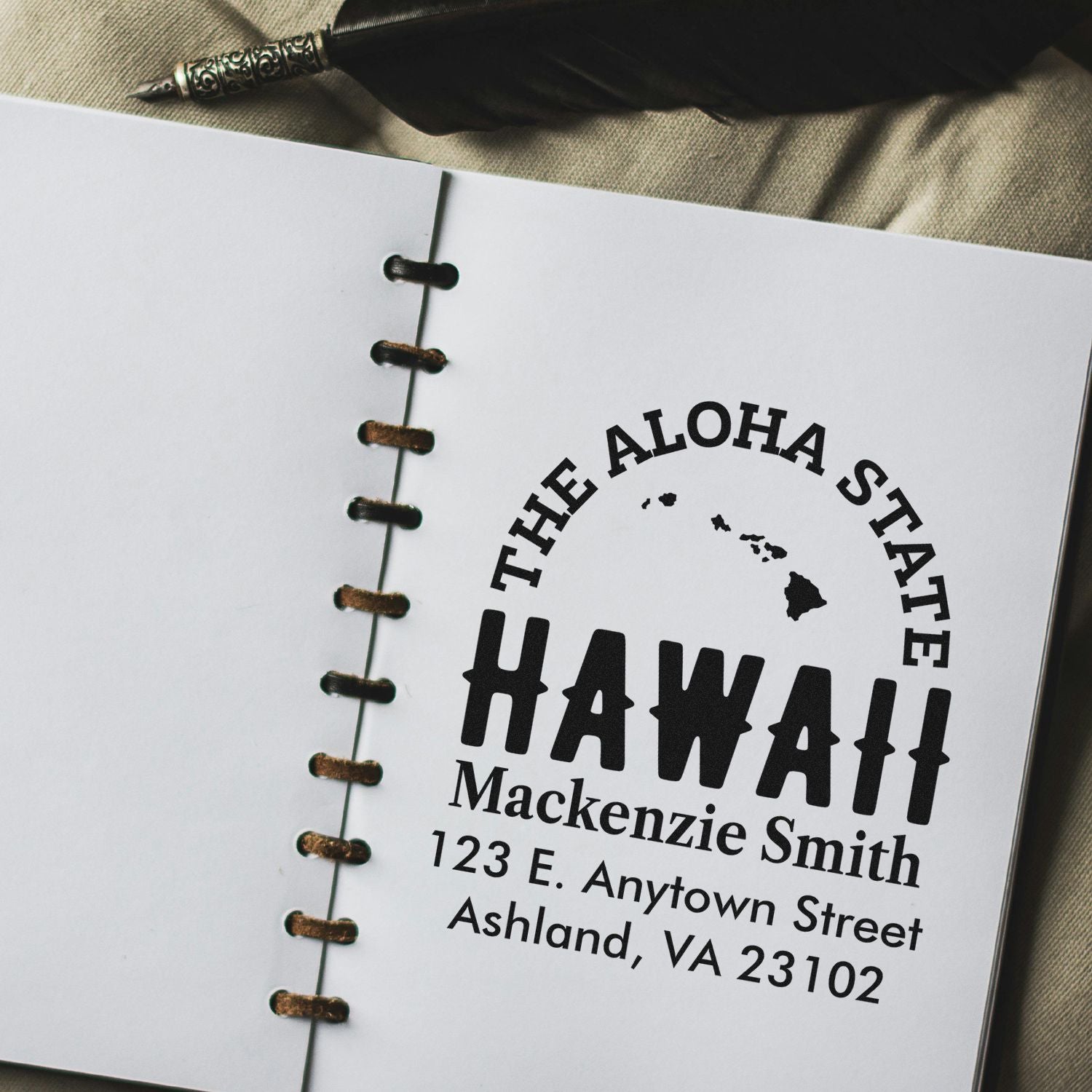 Personalized Hawaii return address rubber stamp with state outline, name, and mailing address on notebook paper.