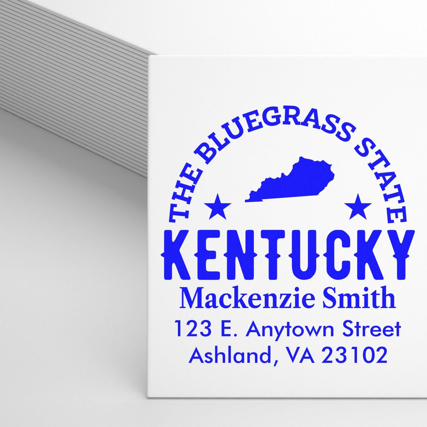 Custom Kentucky address rubber stamp with blue state design, name, and mailing address for Mackenzie Smith.