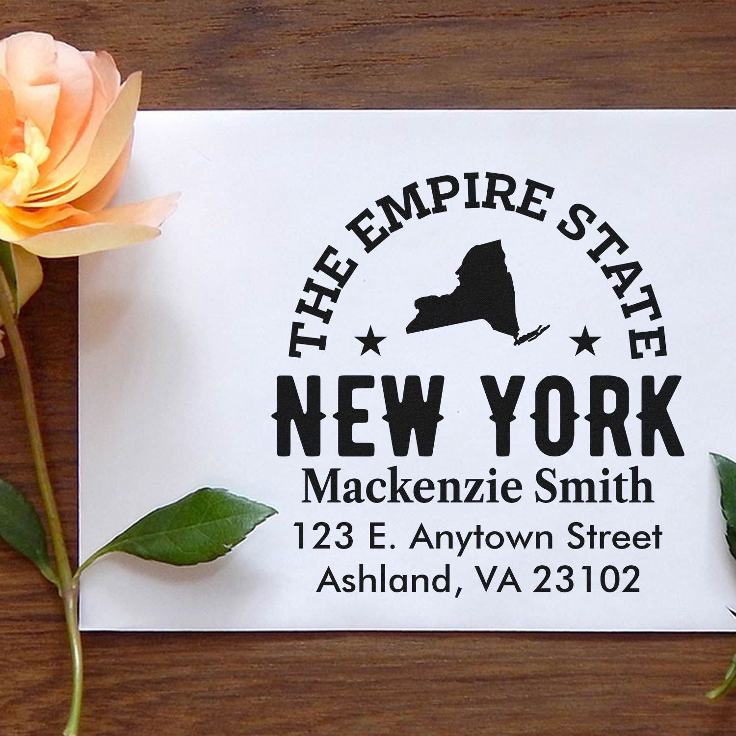 Custom New York return address rubber stamp with Empire State silhouette, name, and mailing address for personalized mail use.