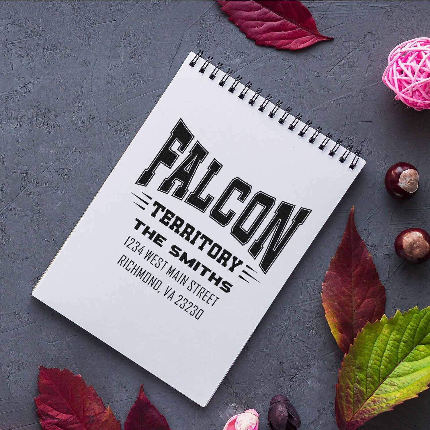 Custom rubber address stamp on notebook, featuring Falcon Territory and The Smiths return address design.
