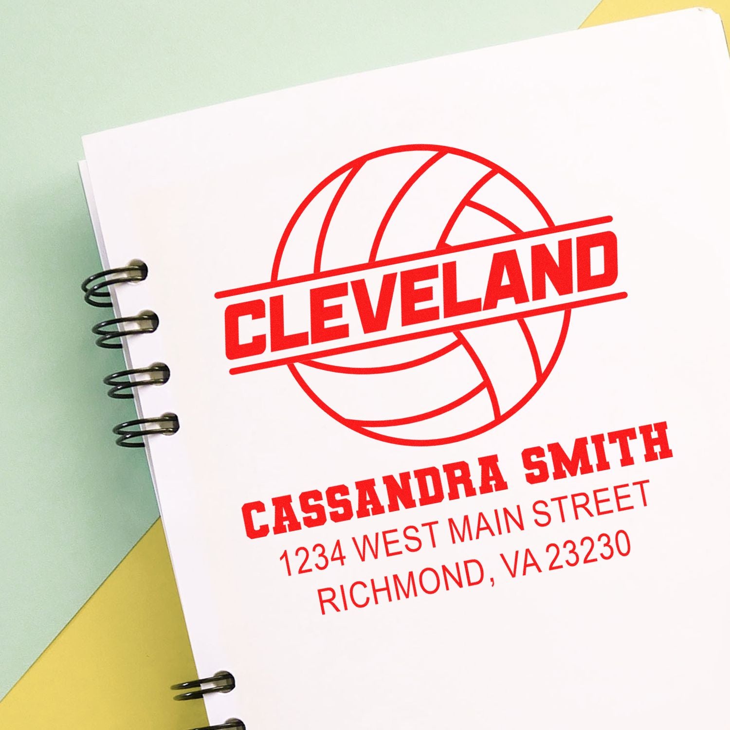 Personalized rubber stamp design with Cleveland volleyball logo, Cassandra Smith name, and address on notebook paper