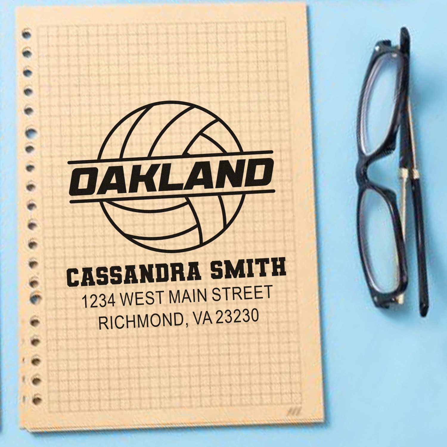 Custom Oakland return address rubber stamp with name and address on notebook, ideal for personalized mailings.