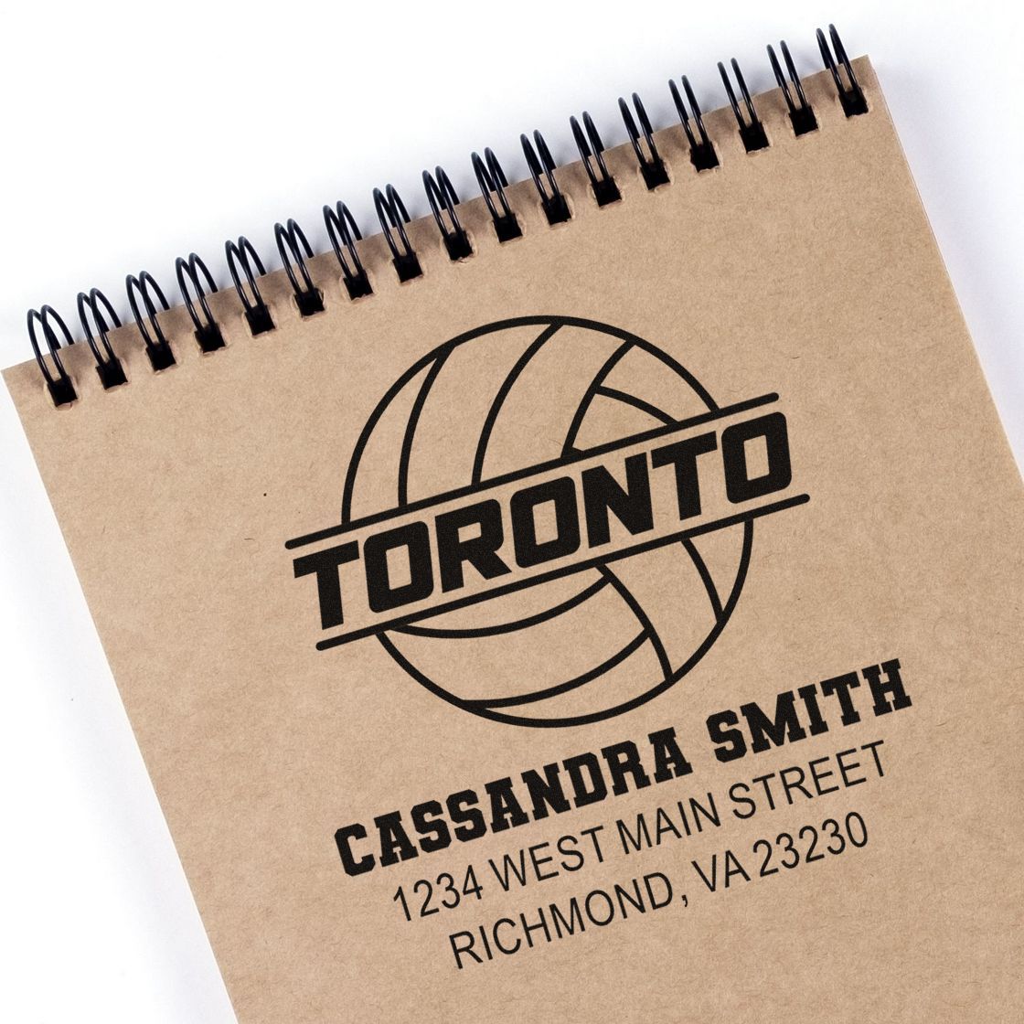 Personalized rubber stamp on kraft notebook featuring Toronto volleyball logo and Cassandra Smith return address in Richmond, VA.