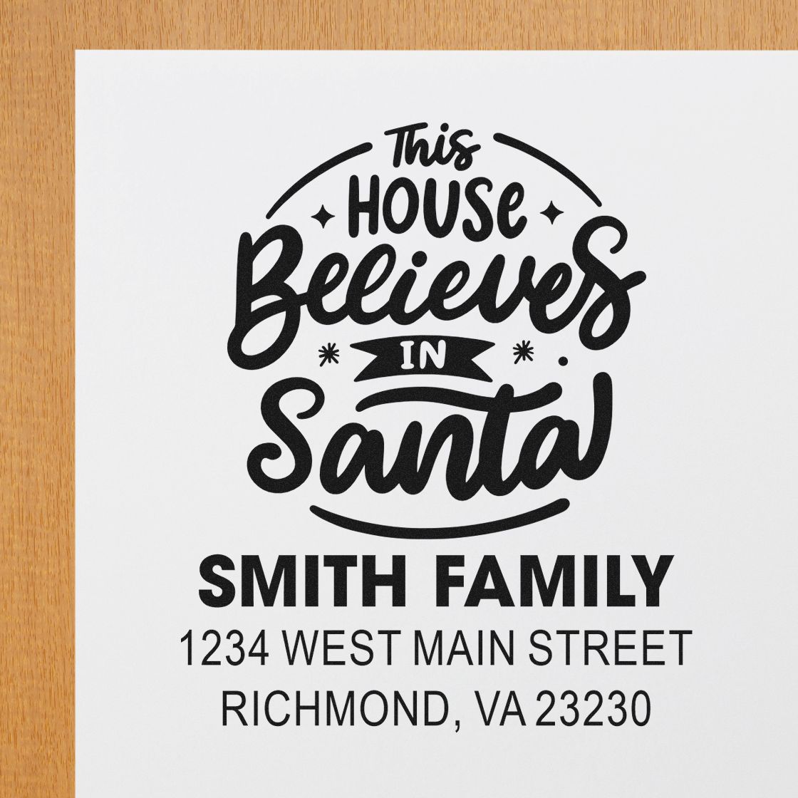 Custom Christmas rubber stamp reading This House Believes in Santa with Smith Family address in Richmond, VA.