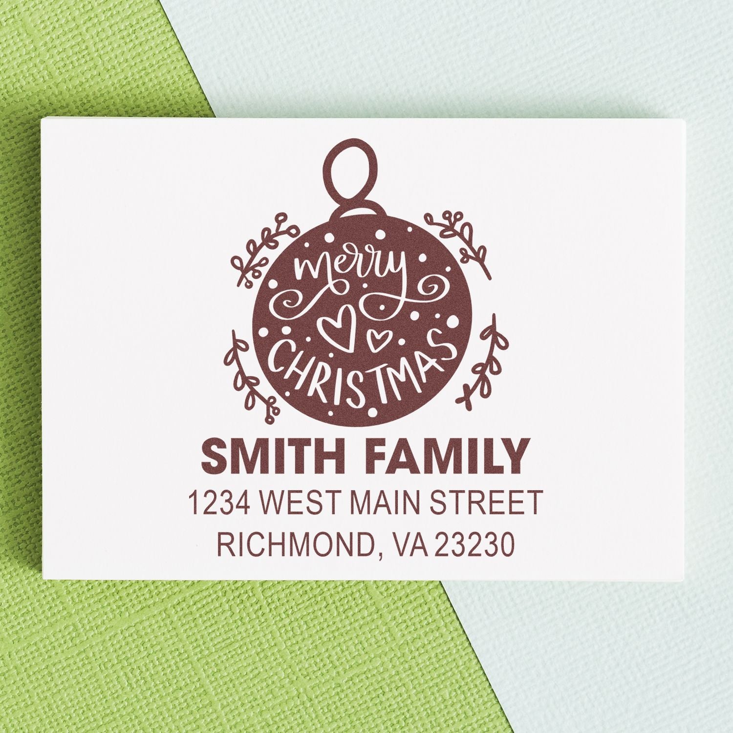 Custom Christmas rubber stamp with Merry Christmas ornament design, Smith Family name, and return address for holiday mail.
