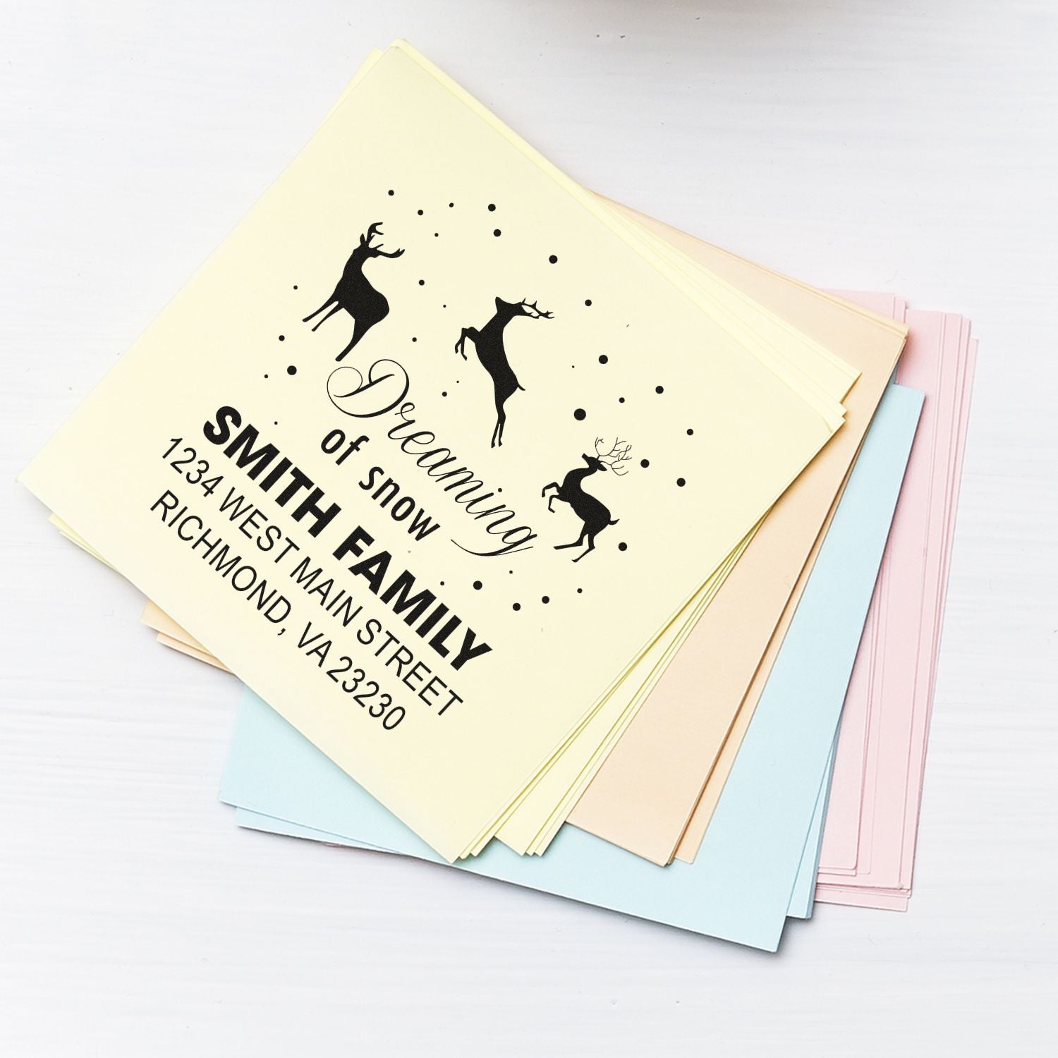 Custom rubber address stamp for the Smith family with deer and Dreaming of snow holiday design on pastel paper
