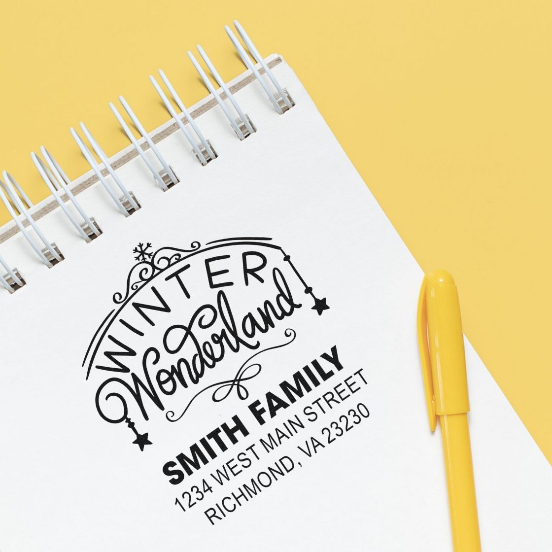 Custom Winter Wonderland address rubber stamp on a notebook with yellow pen