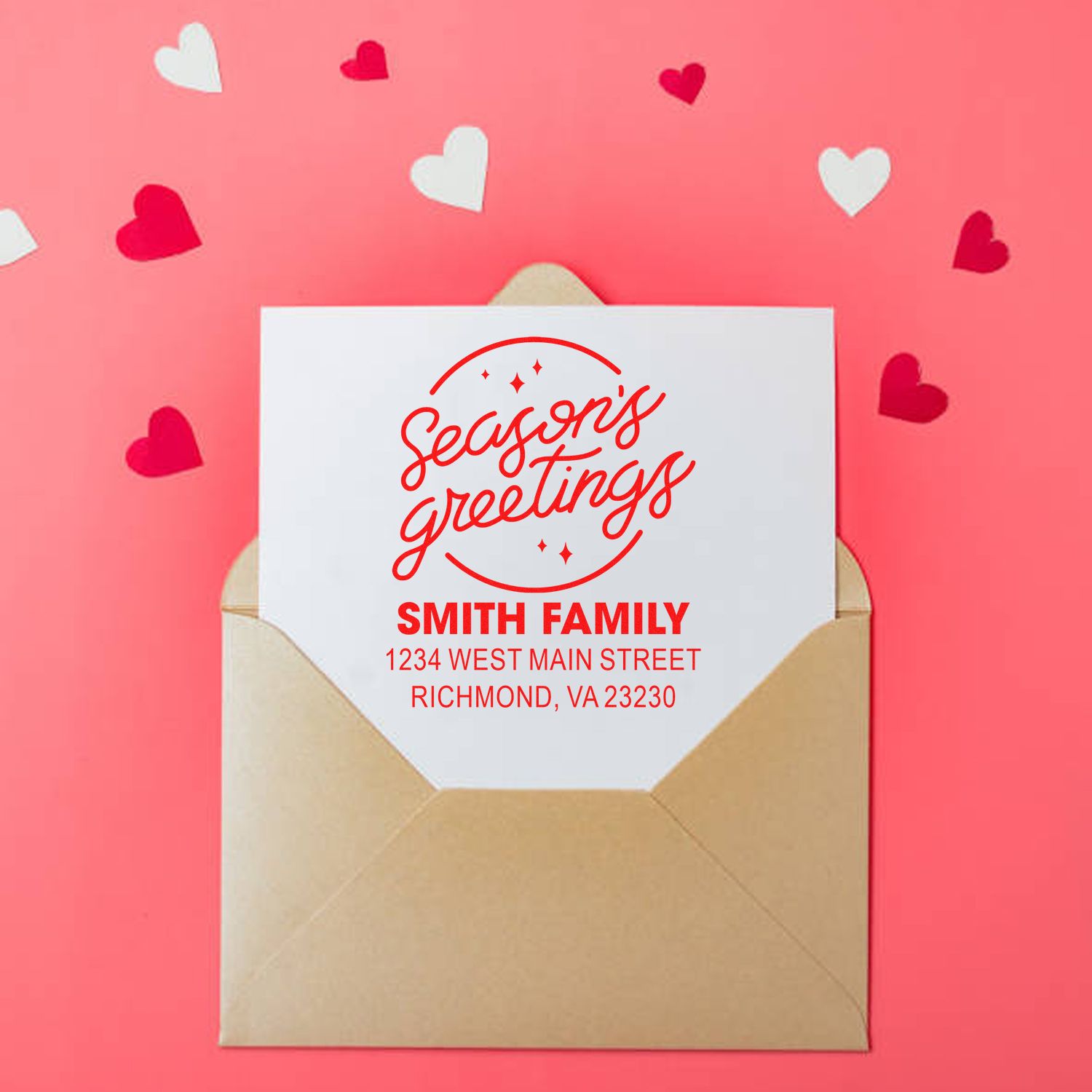 Custom holiday return address rubber stamp with Seasons Greetings for the Smith family on a greeting card envelope.