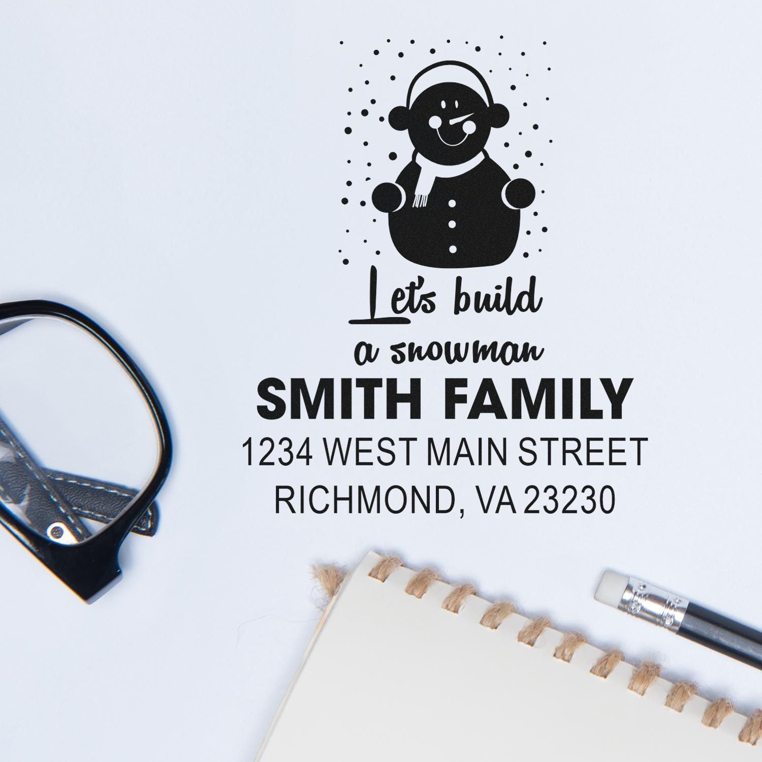 Custom snowman return address rubber stamp with family name and street address.