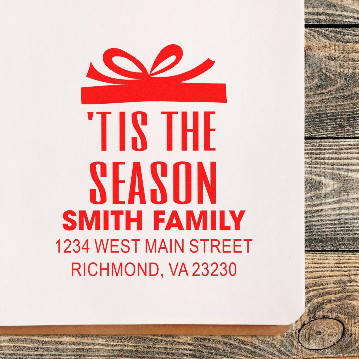 Custom holiday rubber stamp with gift icon, Tis the Season, Smith family name, and return address for Christmas mail.